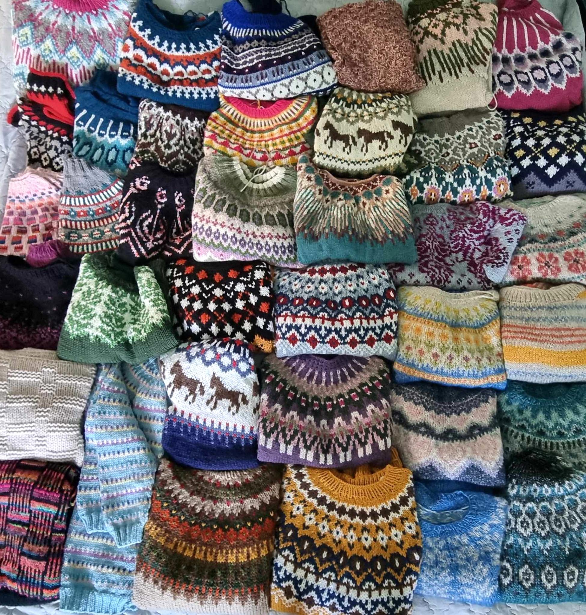 A group photo of many sweaters.
