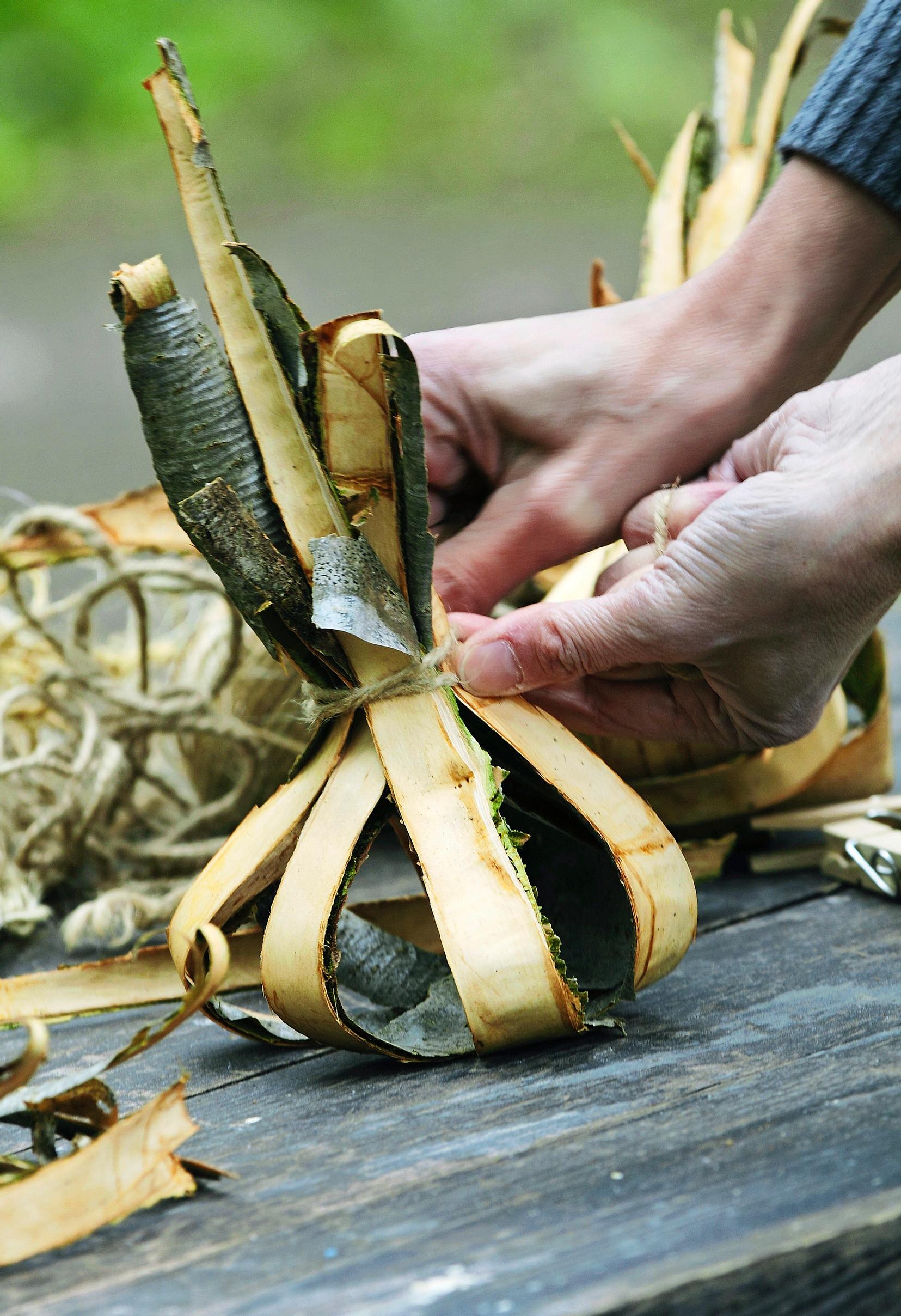Homemade fire starters: tying bark bundles into onion shapes