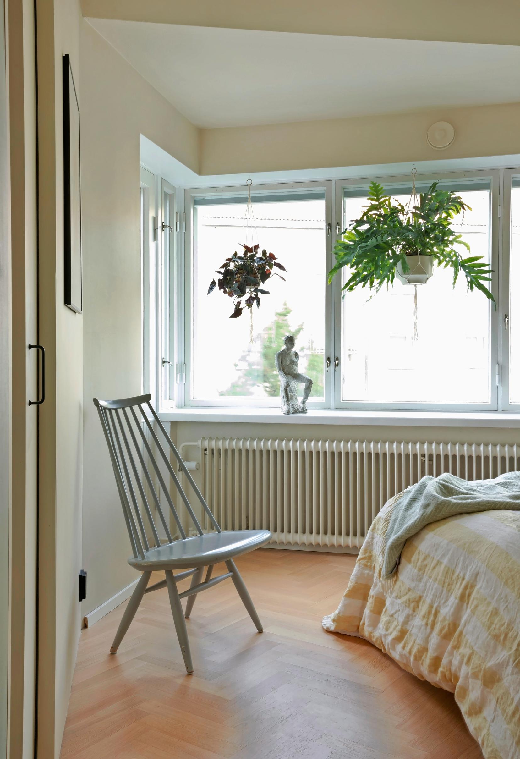 In the bedroom, an angled bay window with deep windowsills