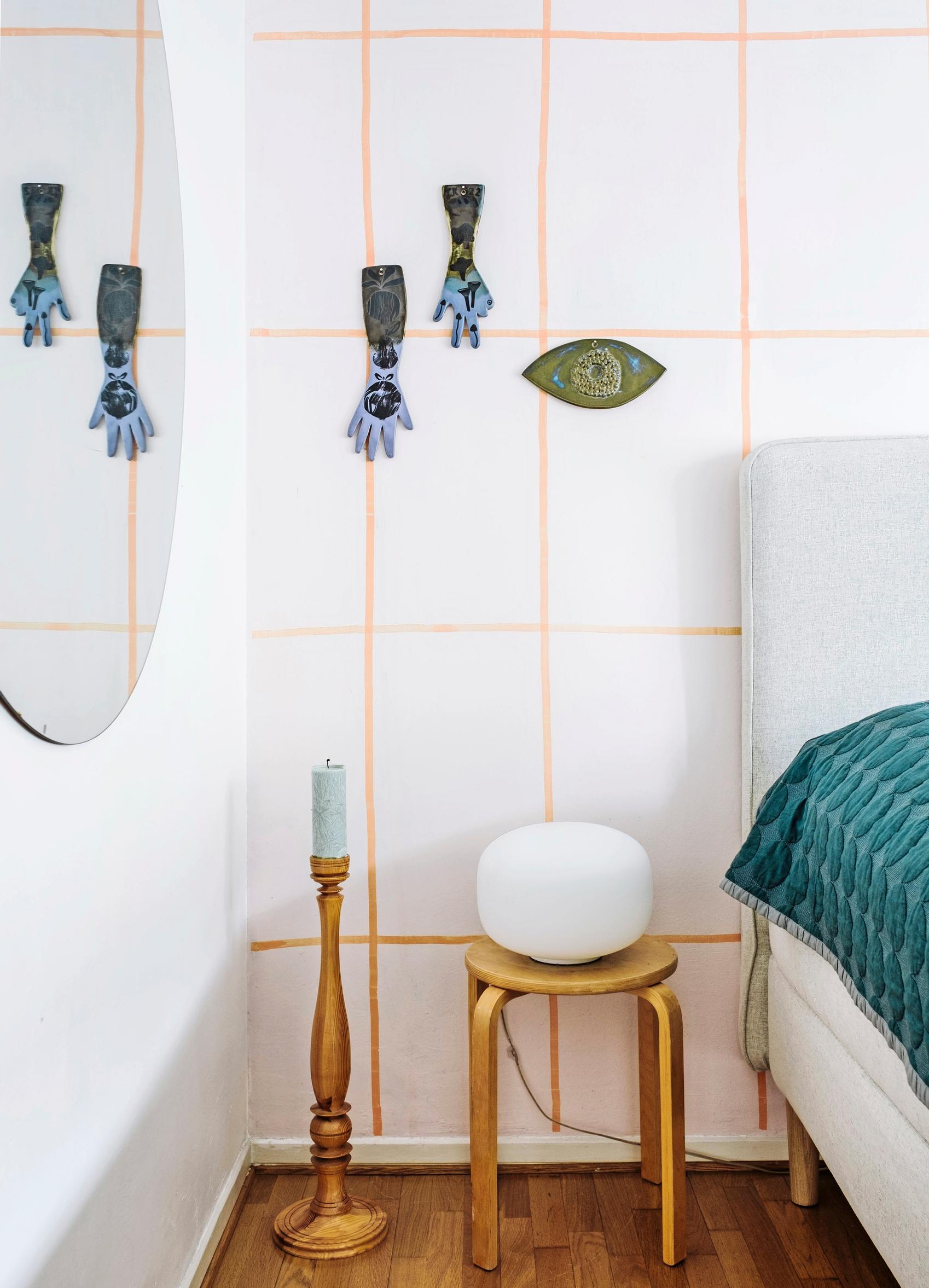 Ceramic hands and an eye displayed on the wall