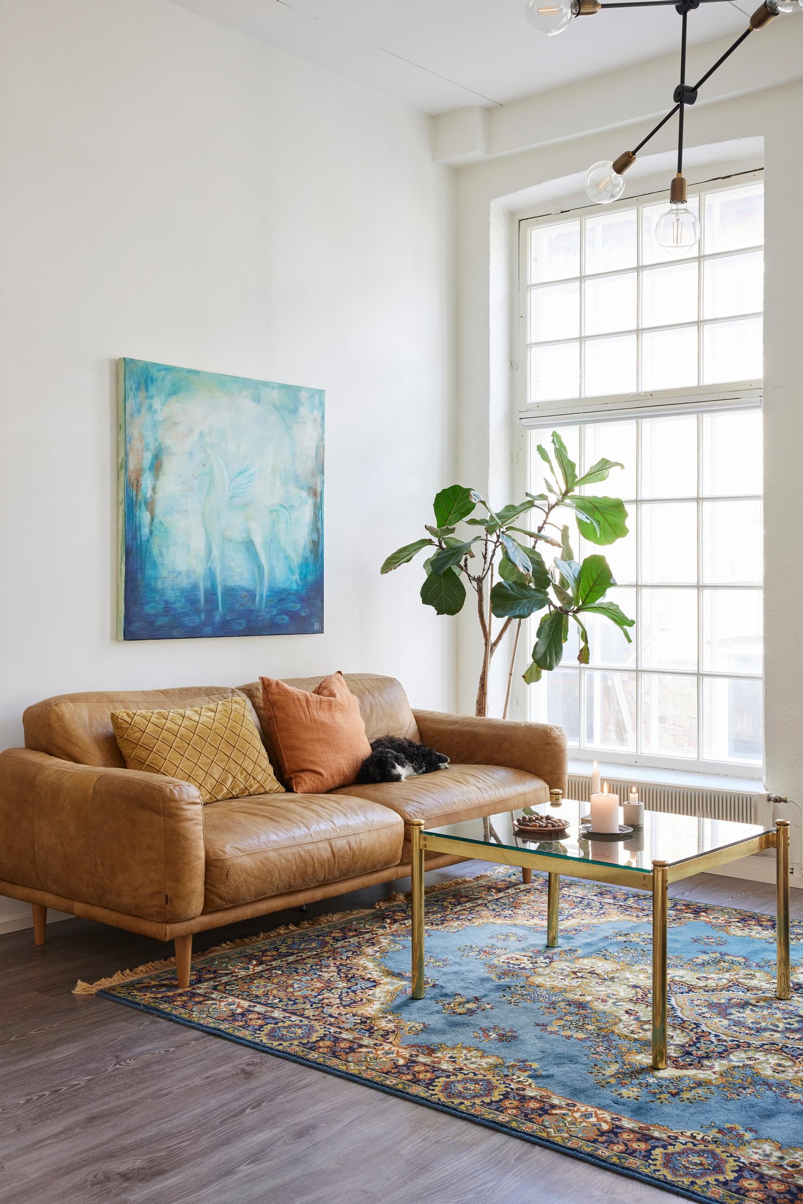 brown sofa and a blue artwork in the living room