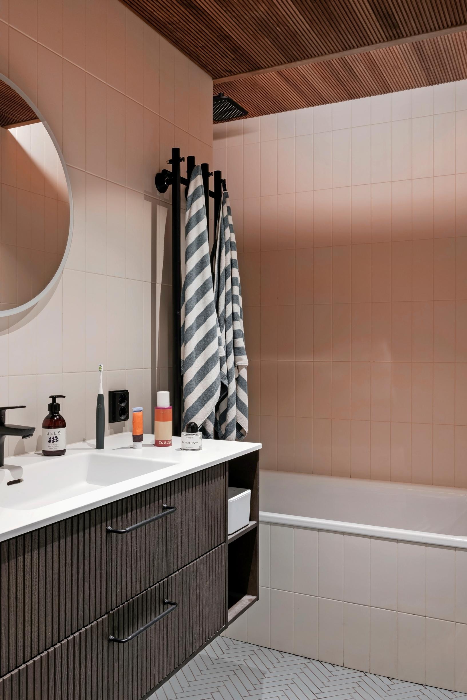 In the bathroom, softly pink tiles