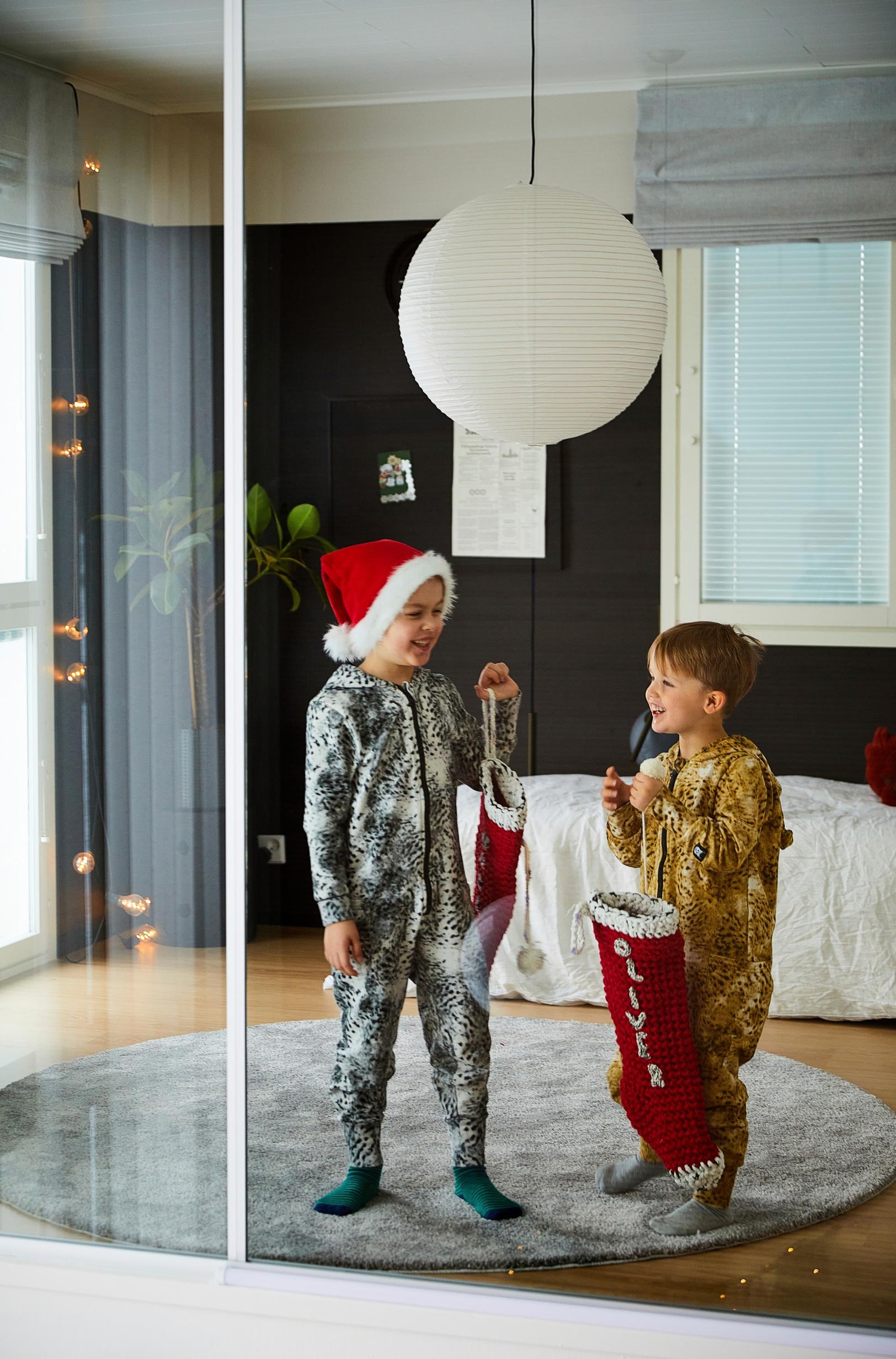 little boys in Christmas outfits on a round rug