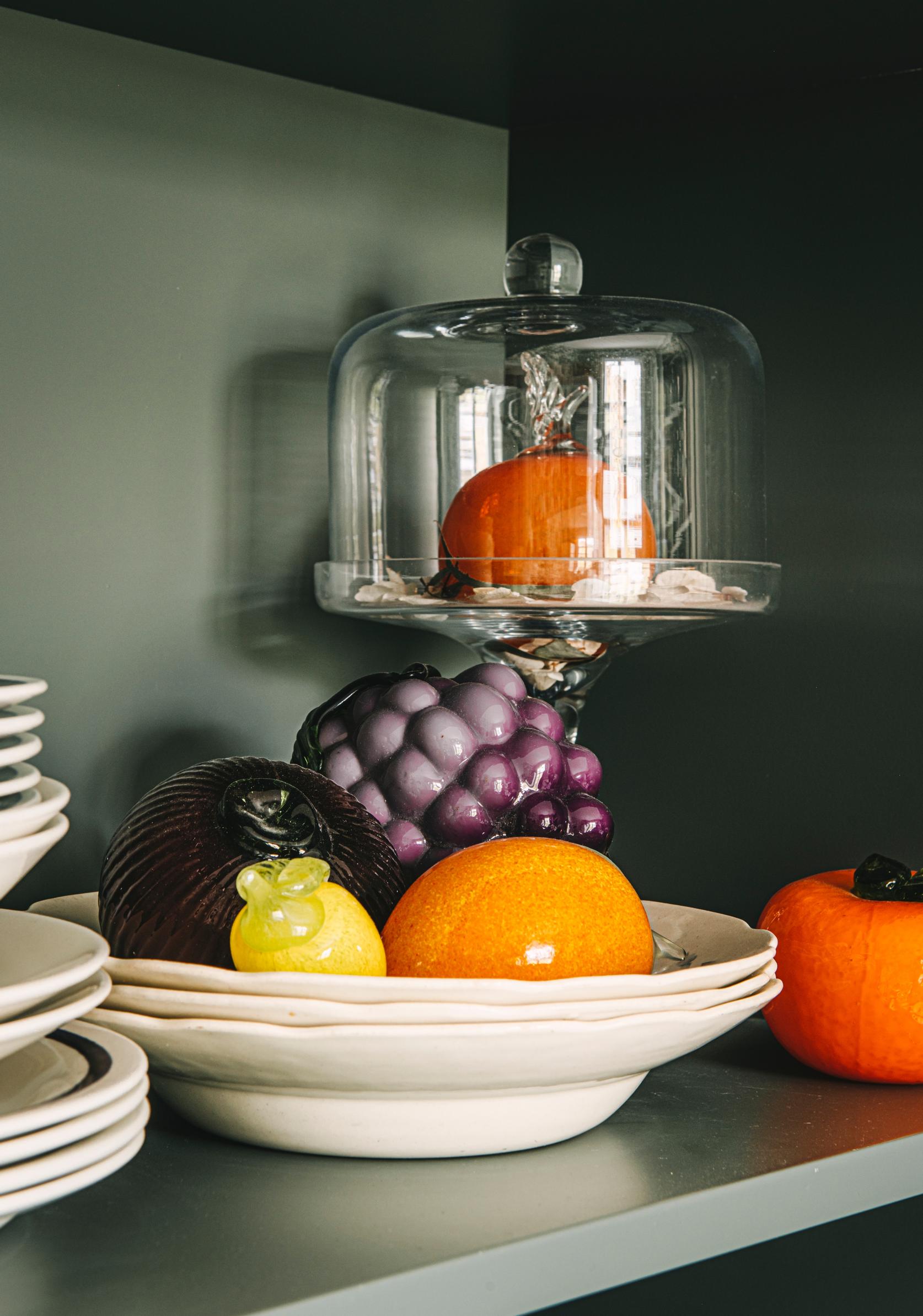 Glass fruits on a stack of plates