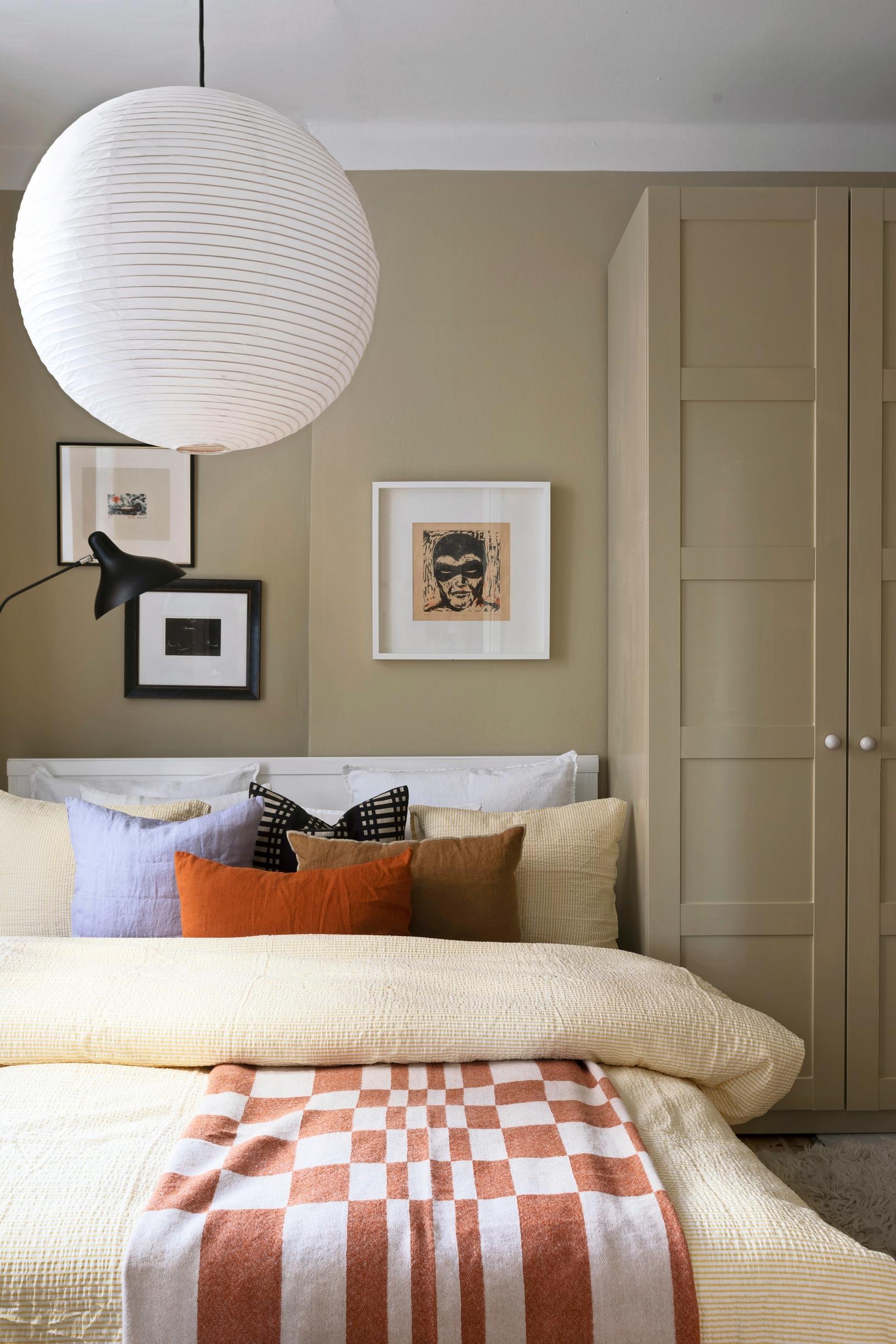 The bedroom wall and wardrobe painted in a muted shade
