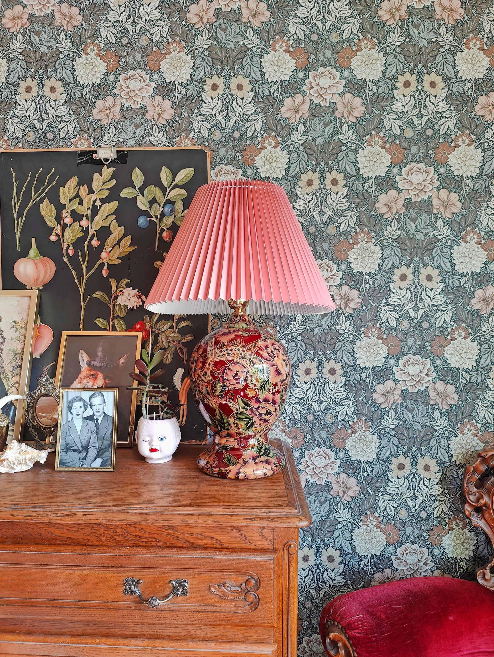 a table lamp on top of a chest of drawers
