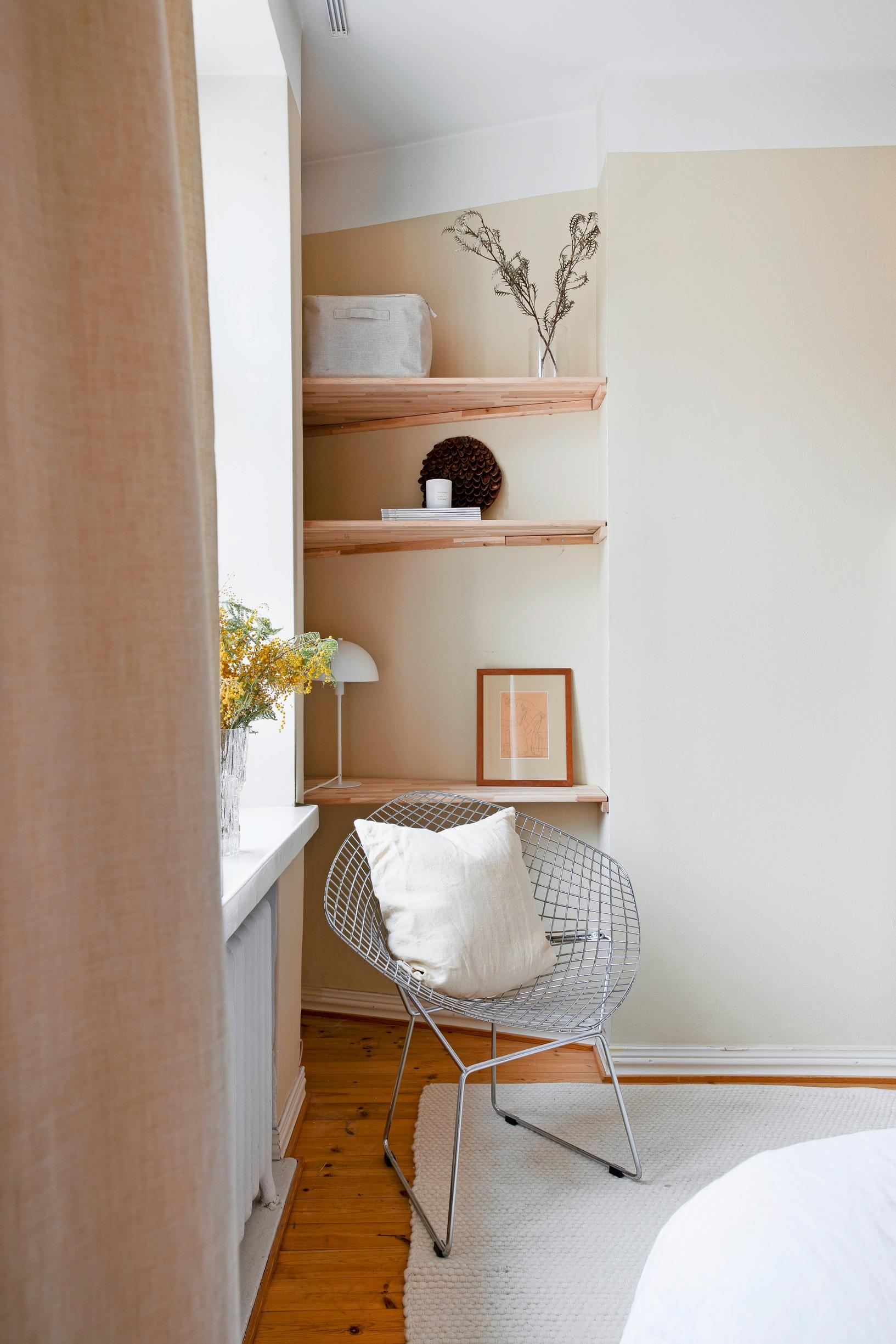 Wooden shelves in a desk nook, set in an angled recess