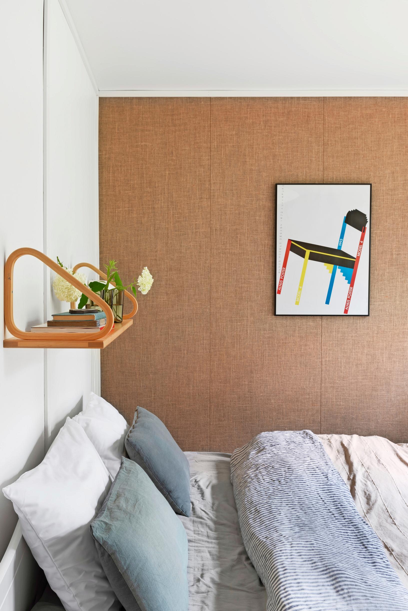 An Artek shelf above the double bed, posters on the wall.