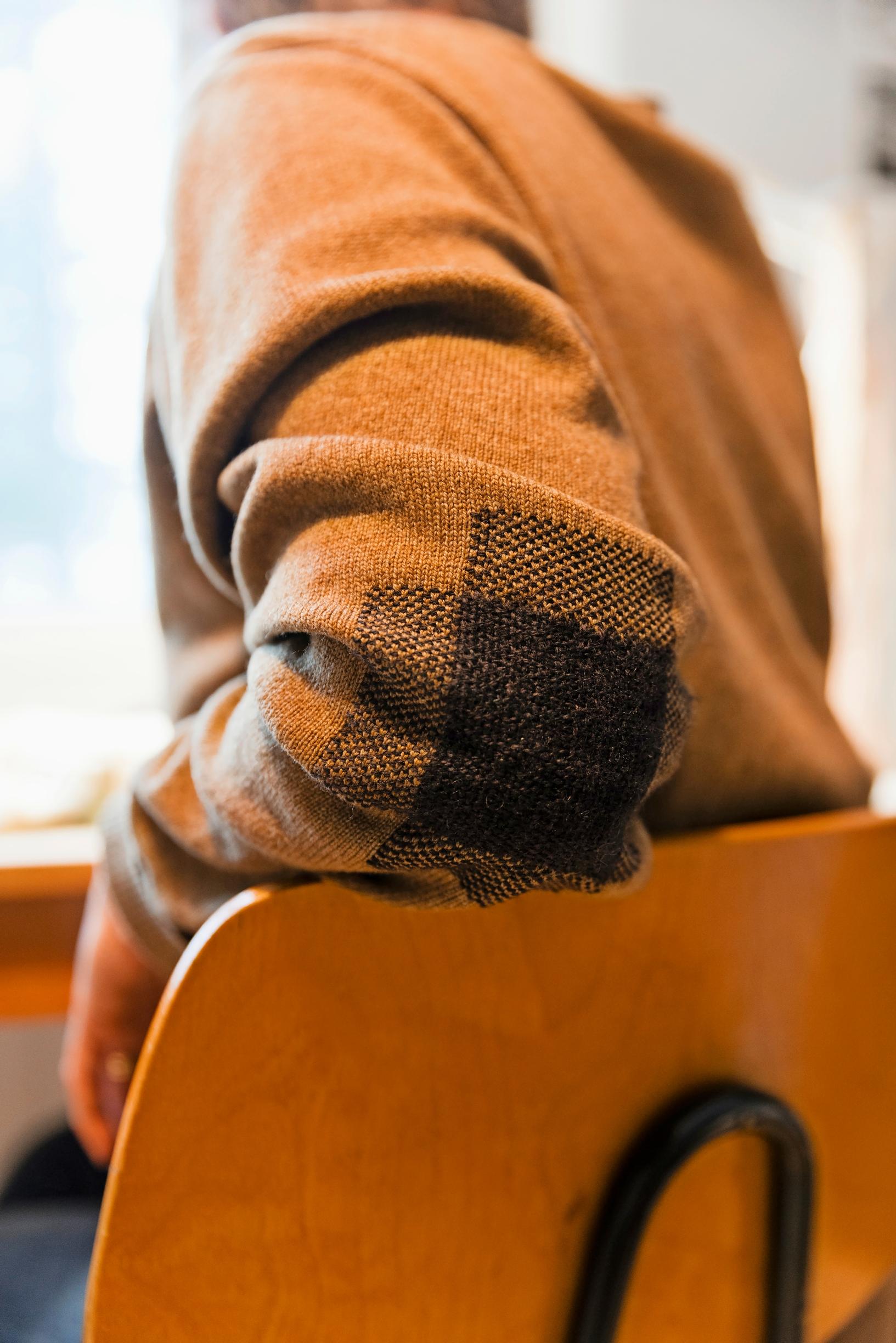 Minttu wearing a cardigan with repaired elbows.