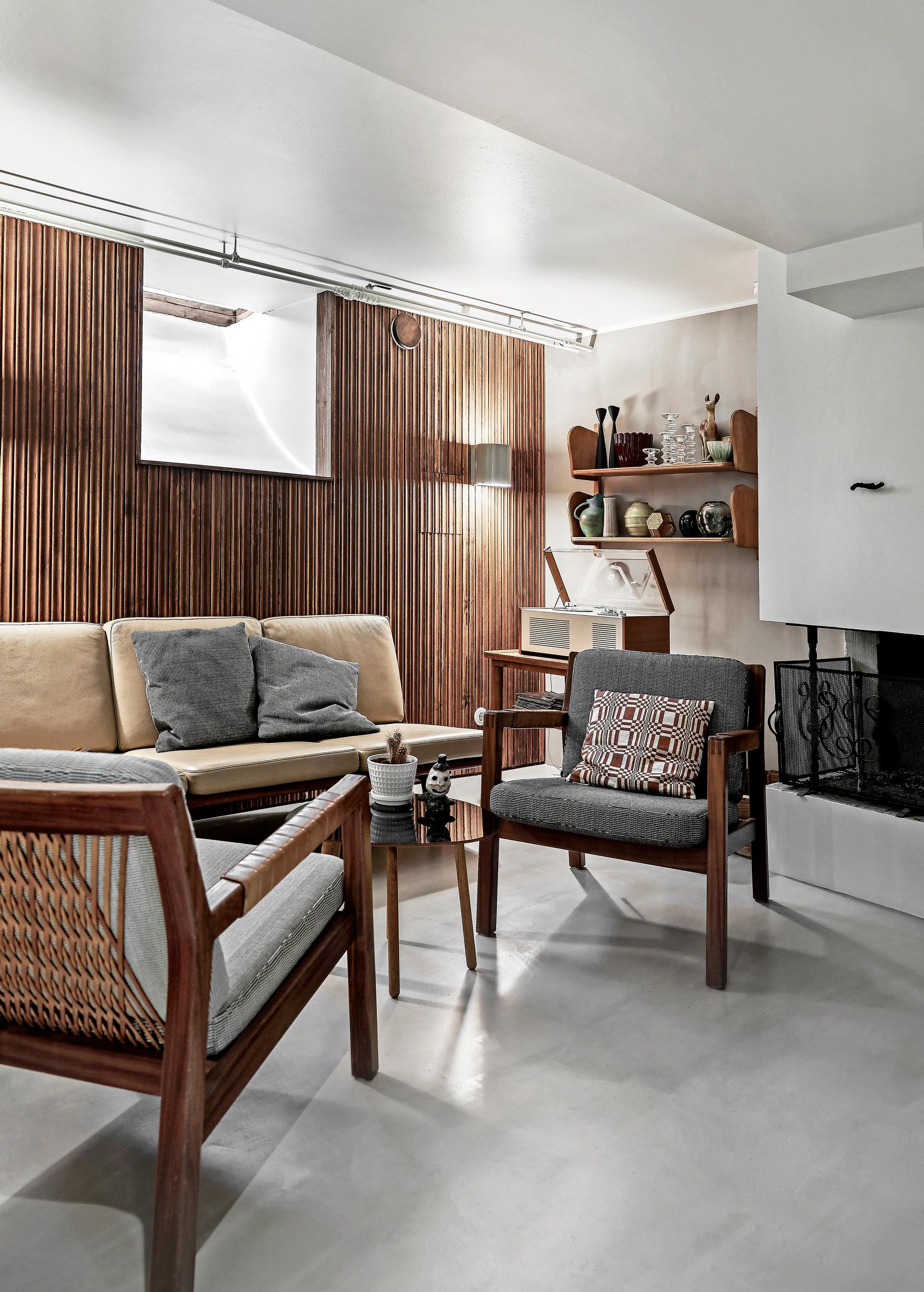 fireplace room with dark wood-paneled wall