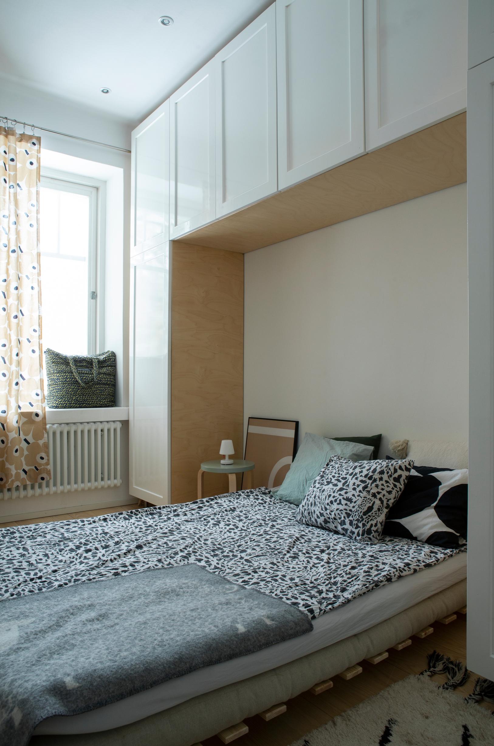 Large wall cabinets surrounding the bed