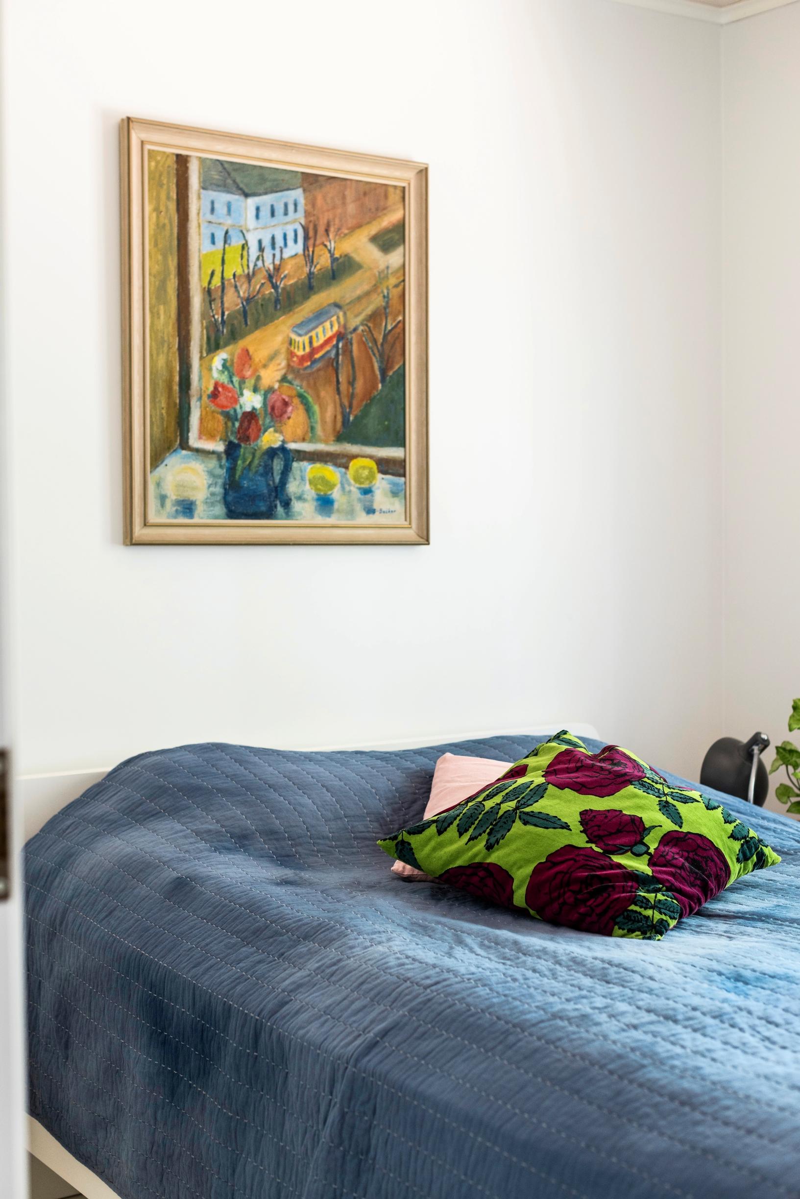 The cottage's guest room with a painting on the wall