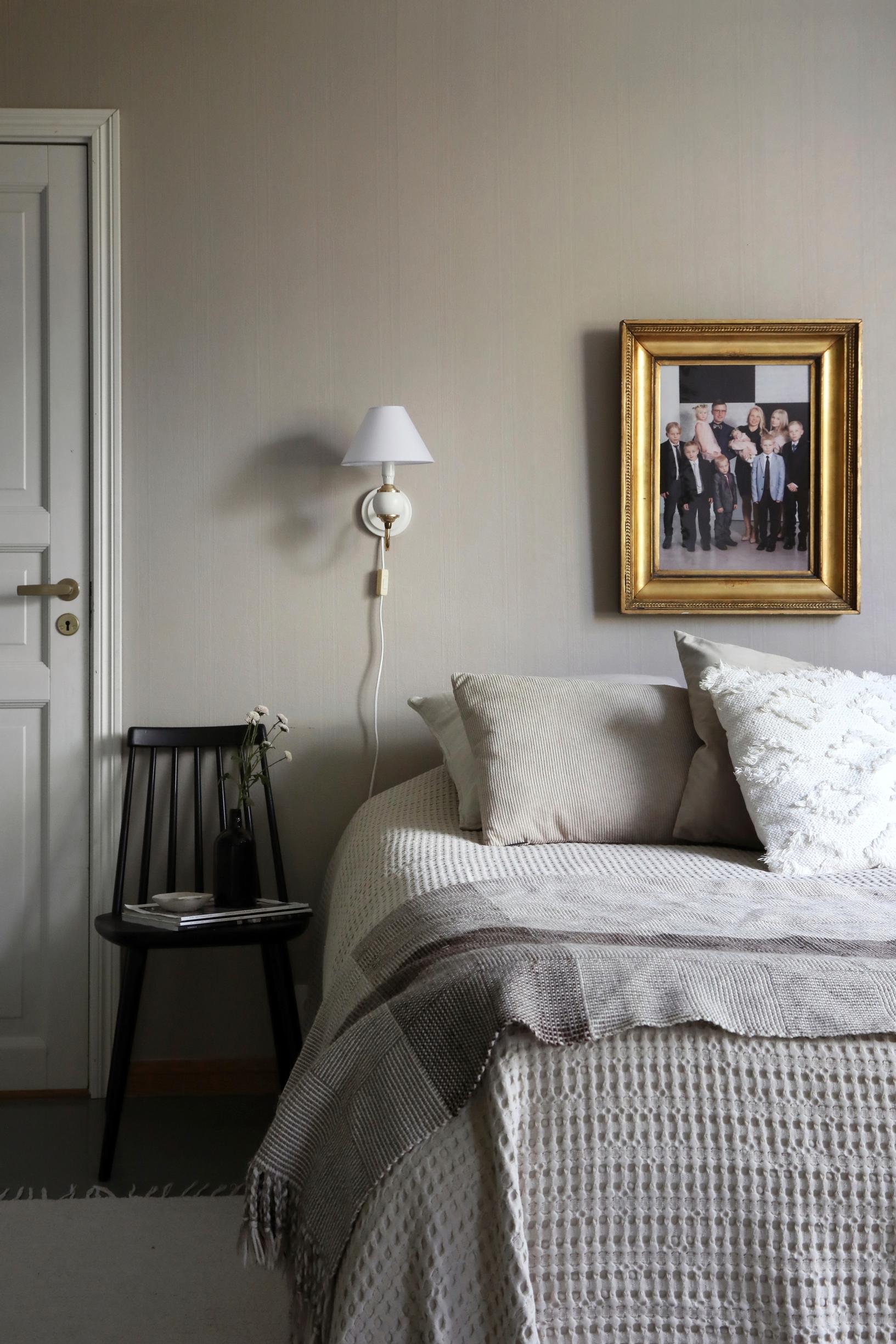 Photo of the bedroom with a chair as a bedside table.