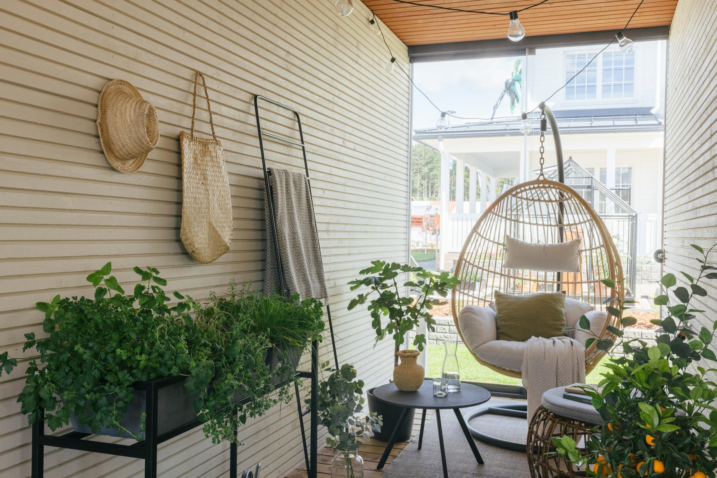 A greenhouse space between a single-family home’s interior and a detached sauna cottage