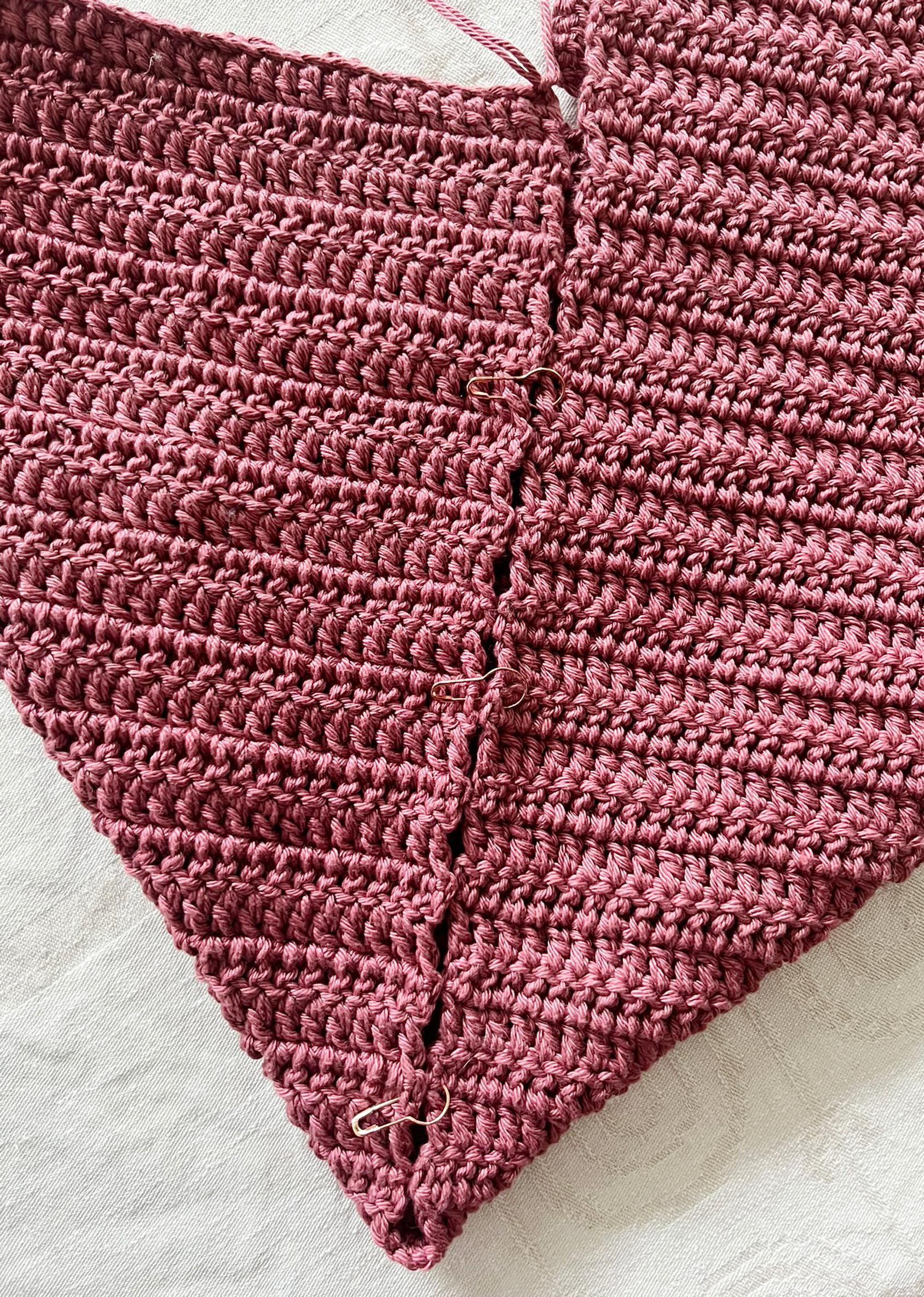 Sewing the edges of the crocheted bag
