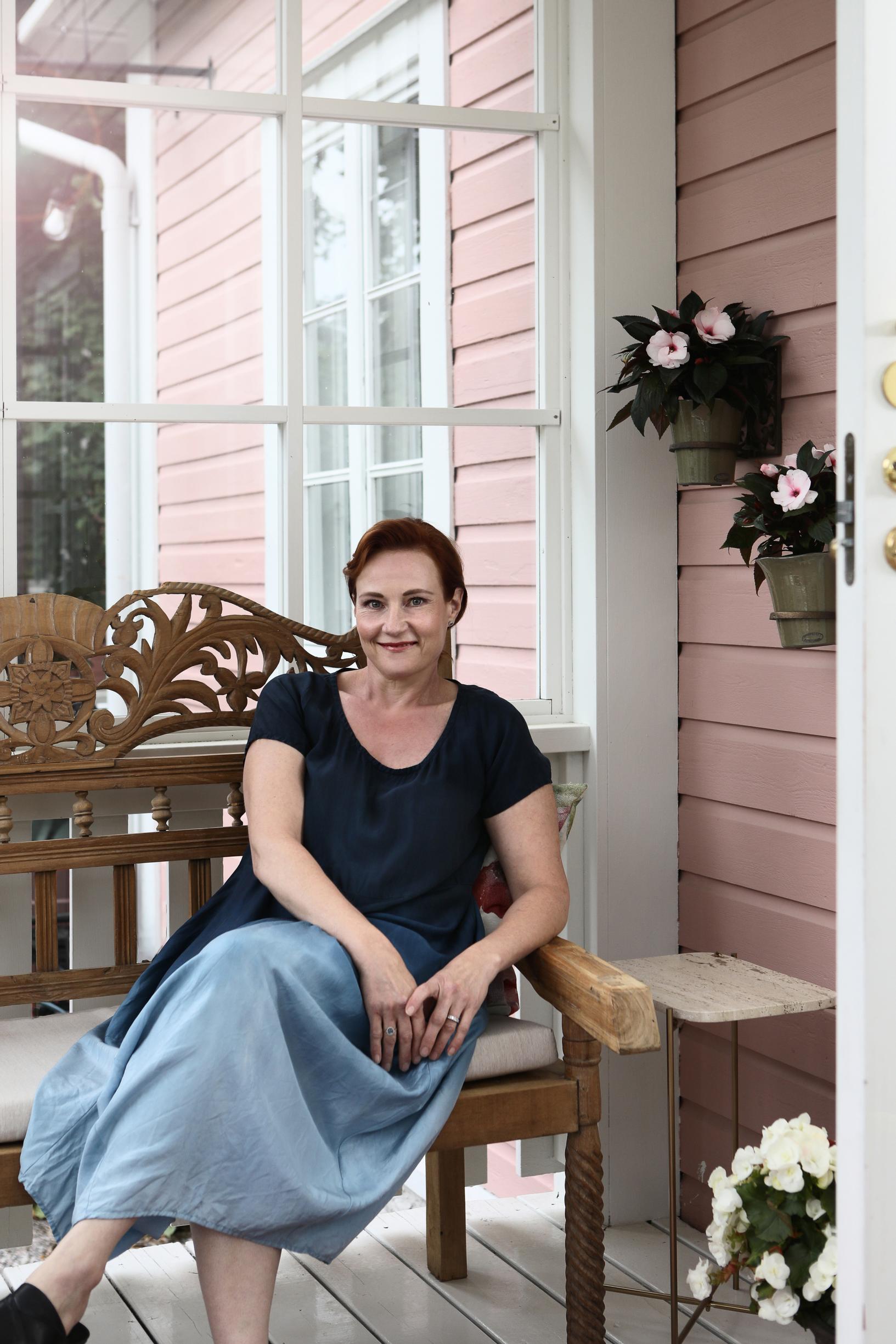 Katja Kantola sits on her porch