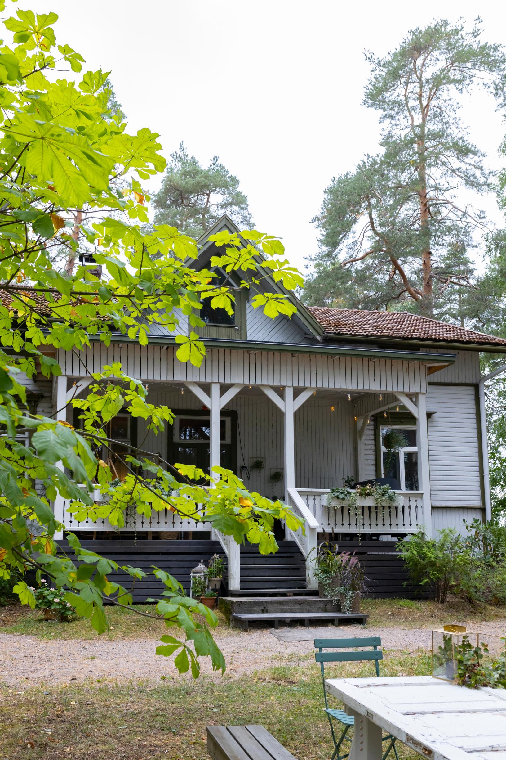 An old wooden villa nestled among trees.