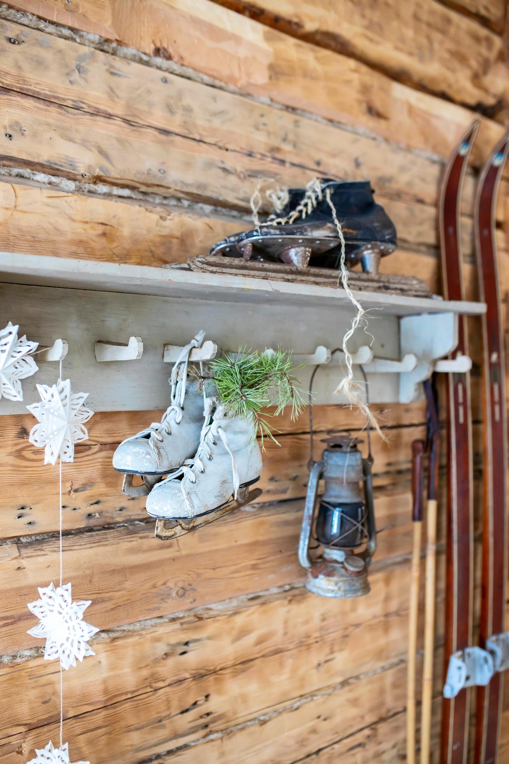 Christmas ornaments hanging from an old wall rack