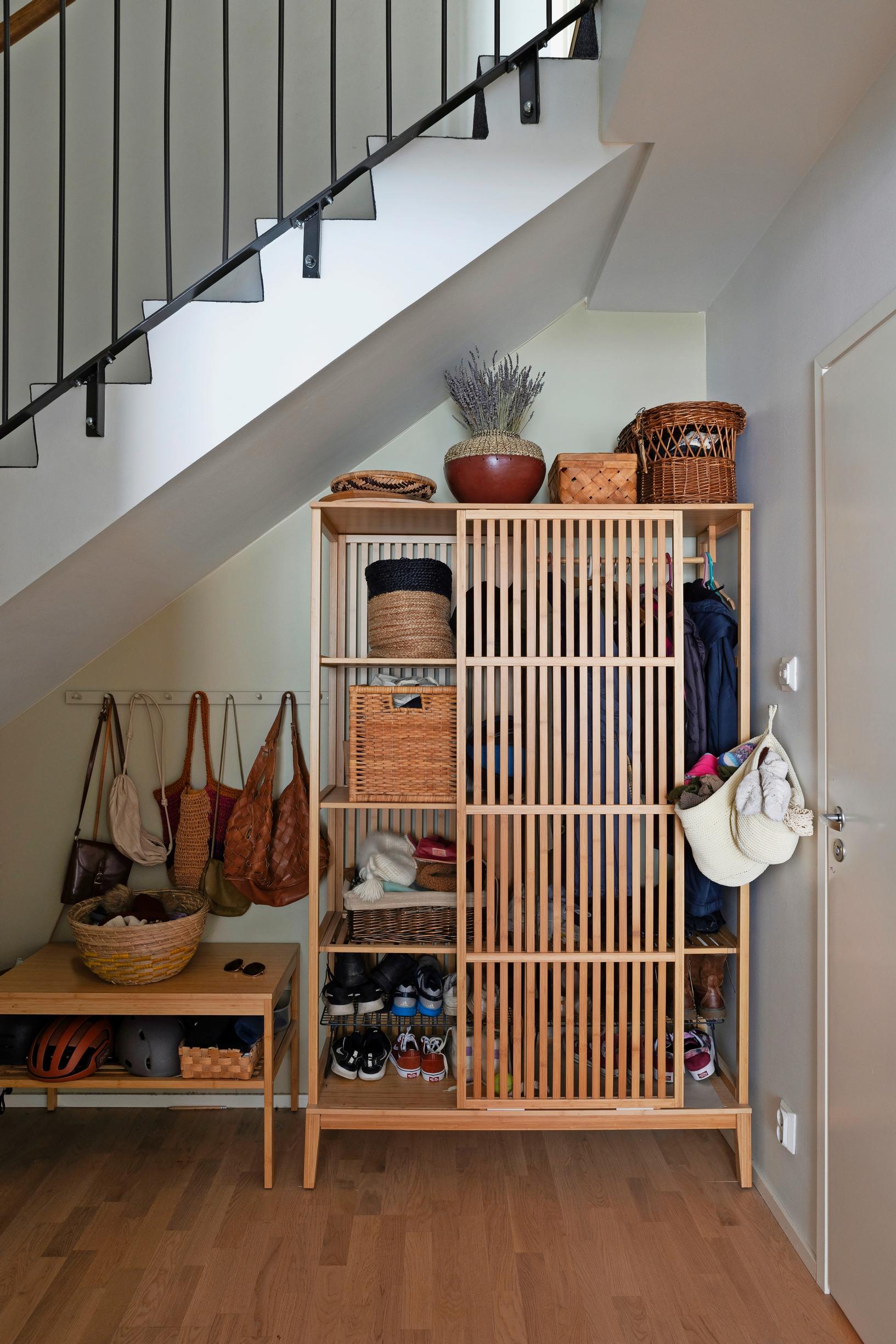 Photo of the storage solutions under the stairs in the entryway.