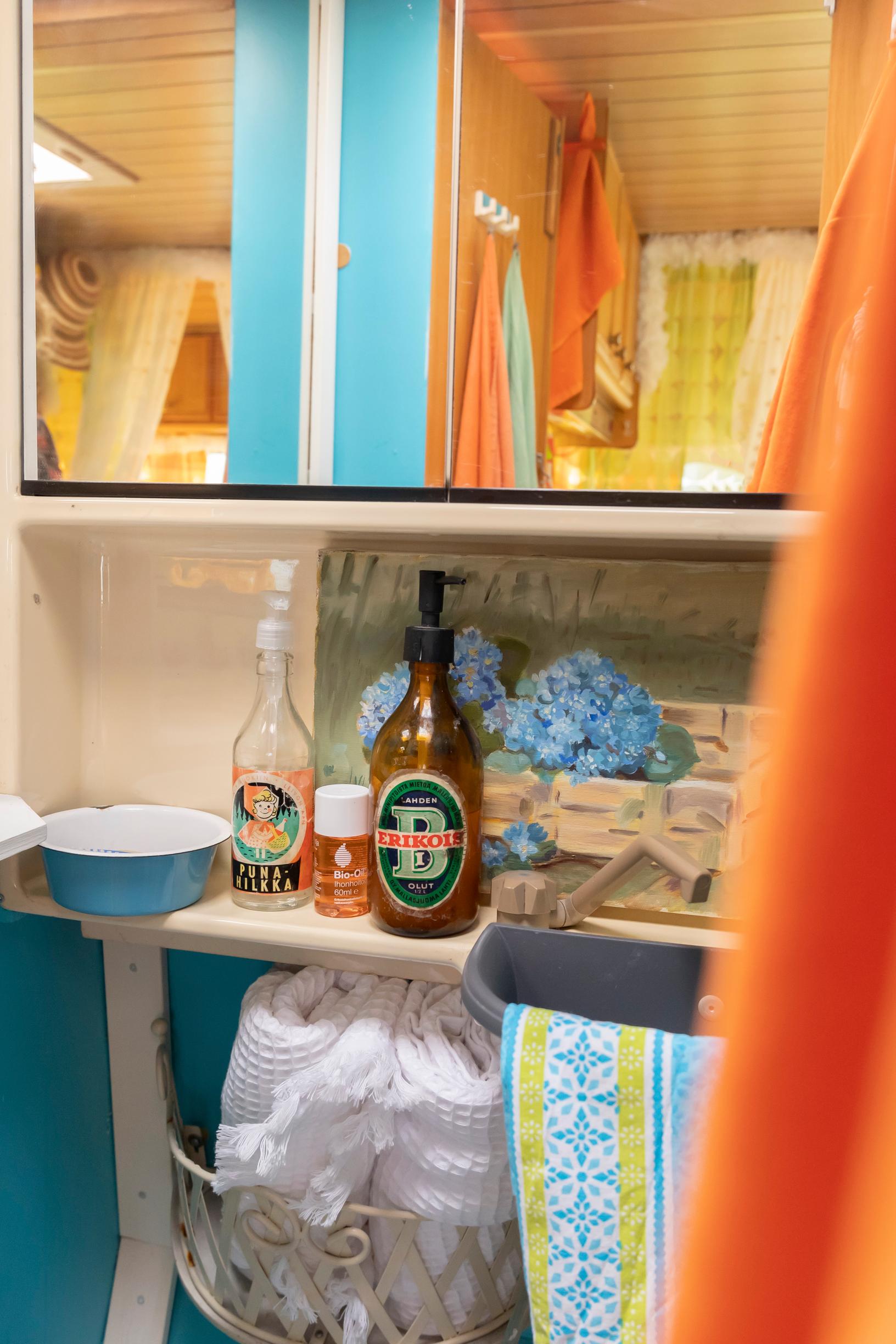 bath supplies and toiletries on colorful bathroom shelves in the travel trailer