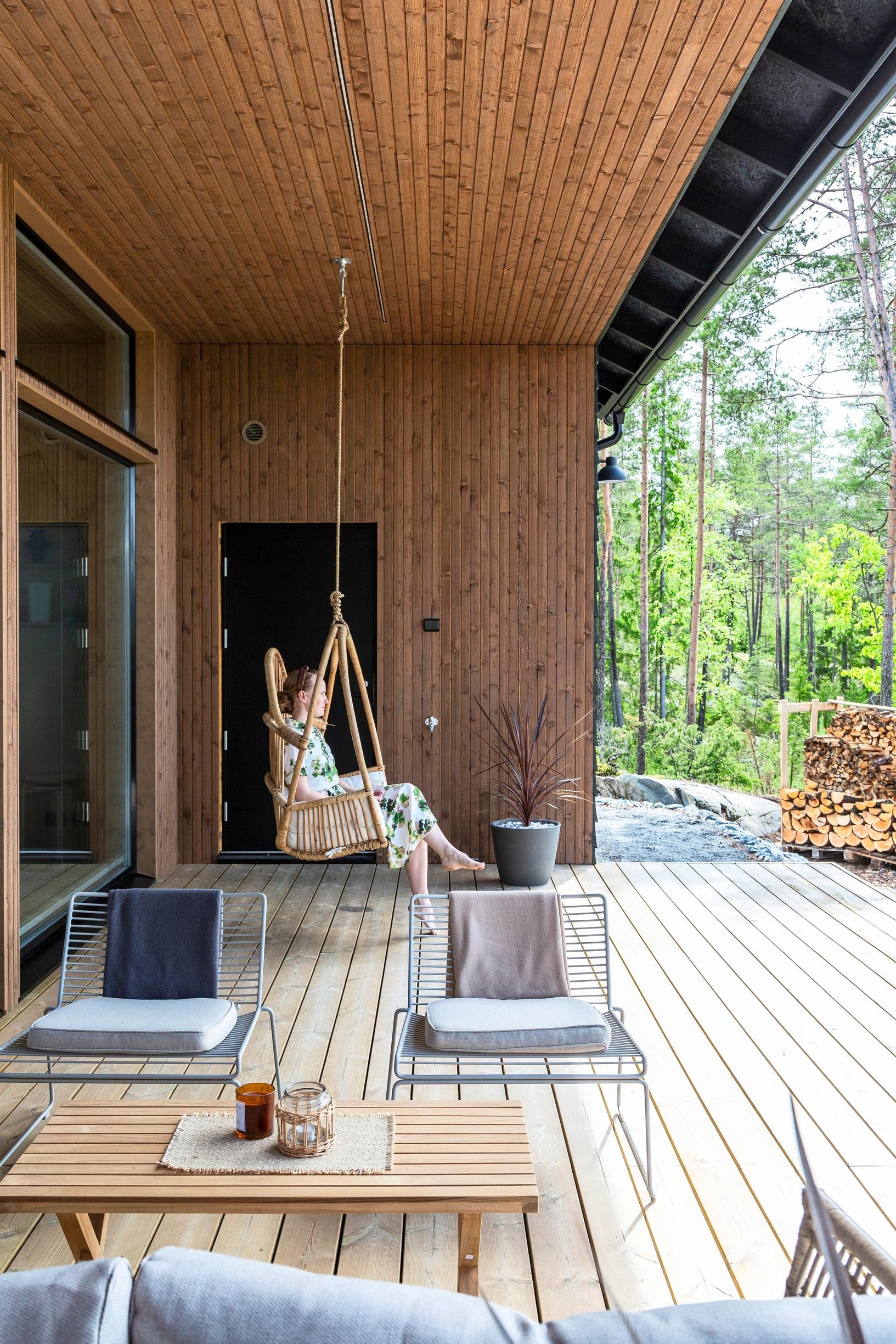 A rattan hanging chair on a covered terrace