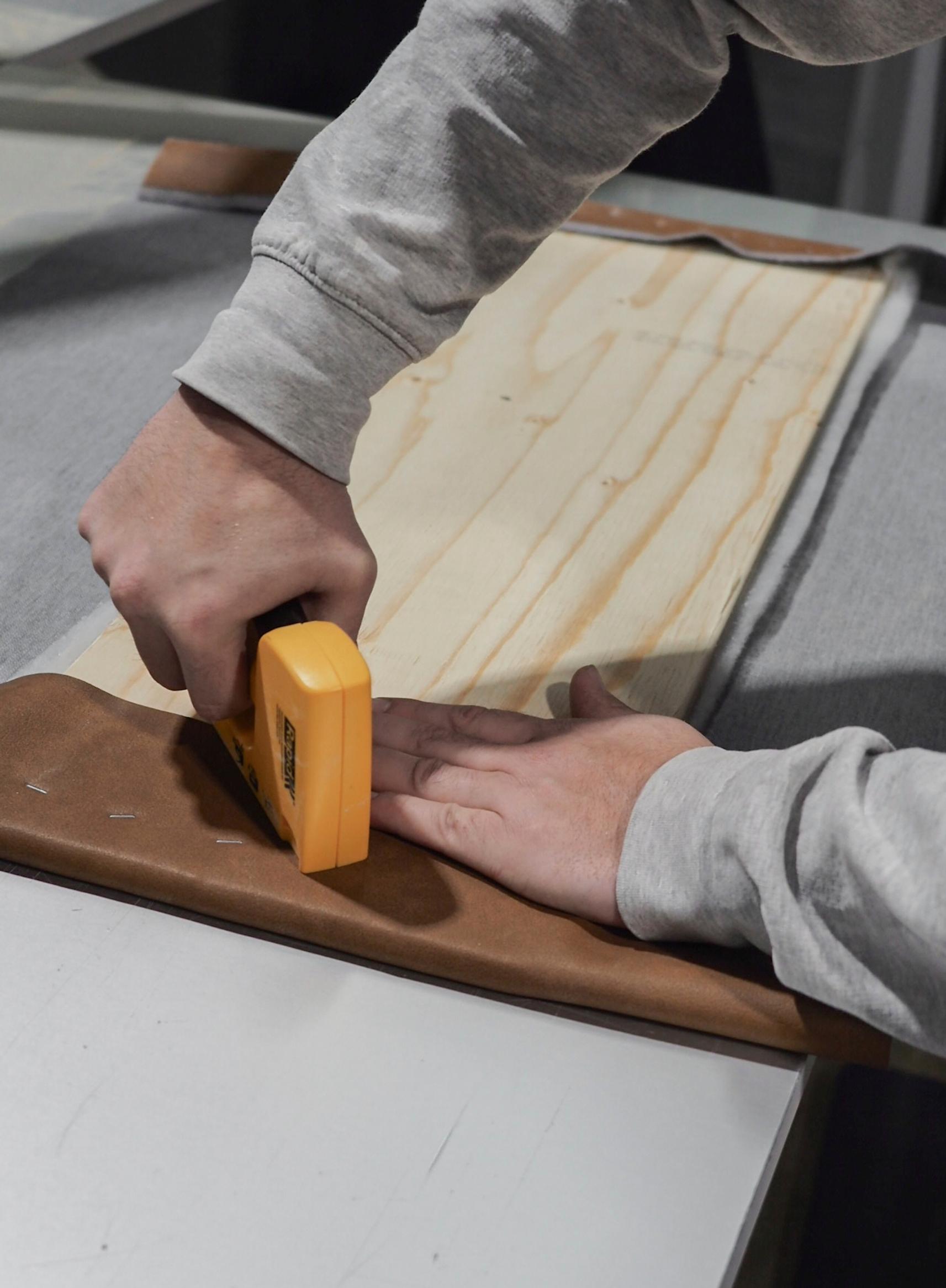 Stapling the cover fabric to the plywood