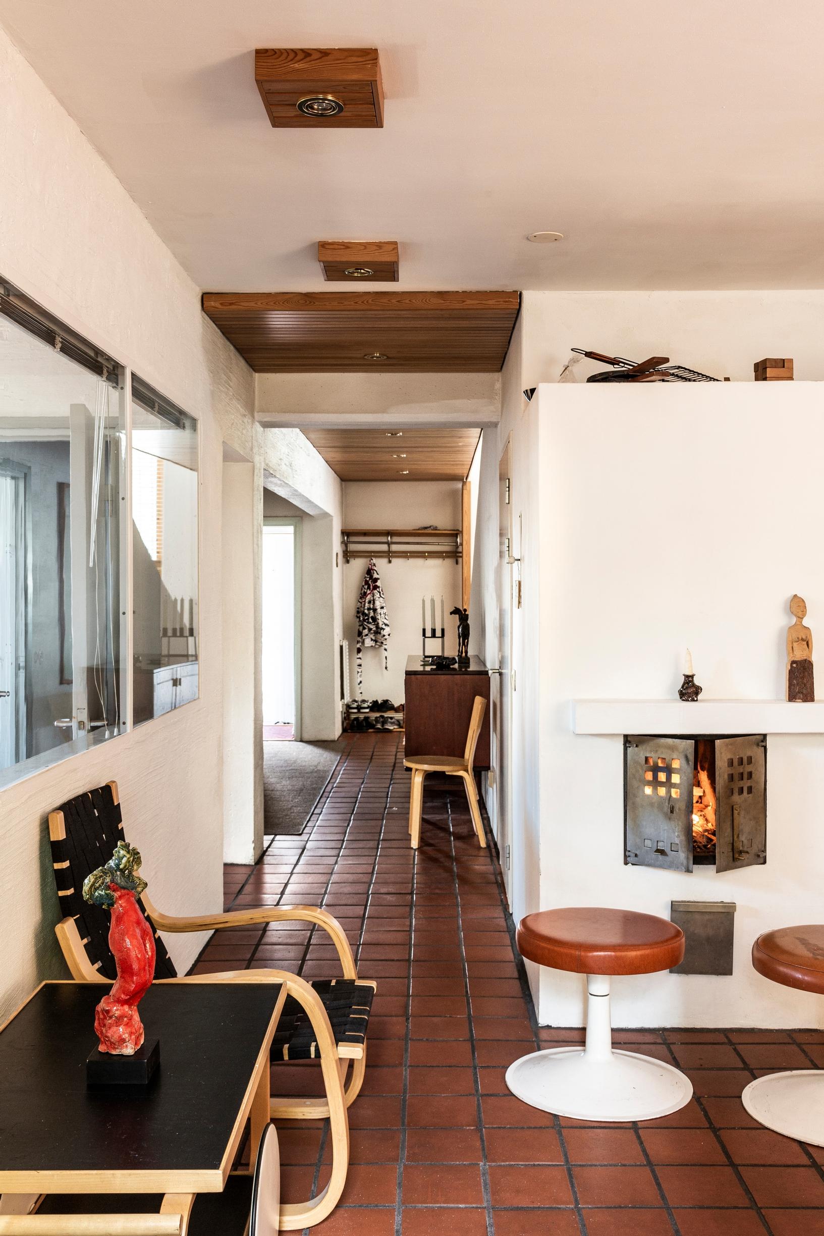 Fireplace in the home created from Alvar Aalto’s old heating plant, stools, and Aalto furniture