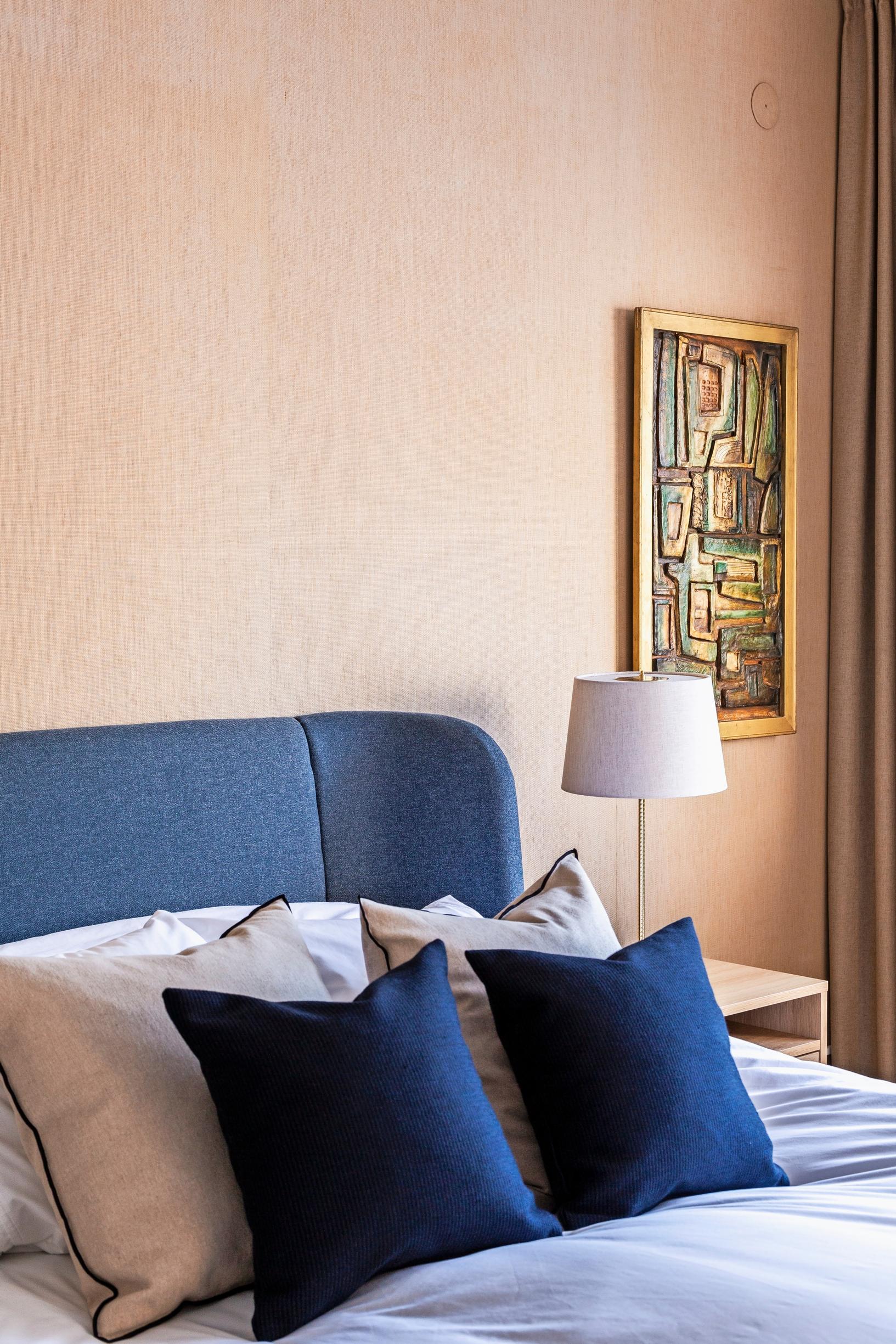 In the bedroom, a blue headboard