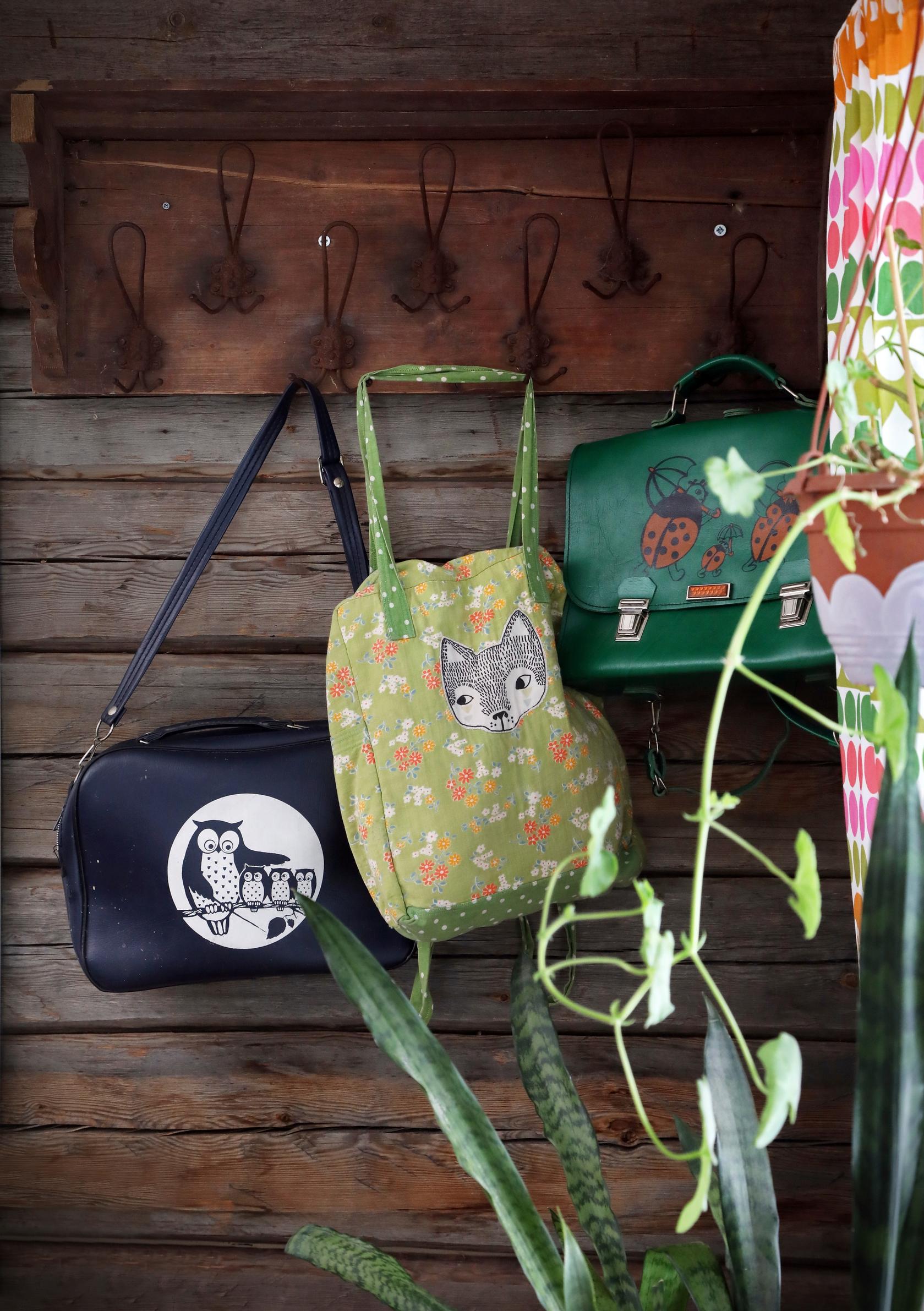 A rack on the log wall filled with fun bags.