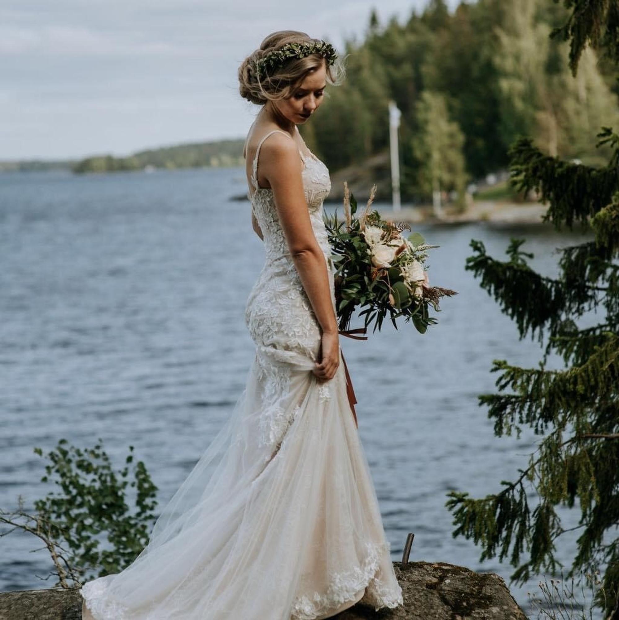A beautiful bride and gown by the shore. Photo by Amanda Lehtola.