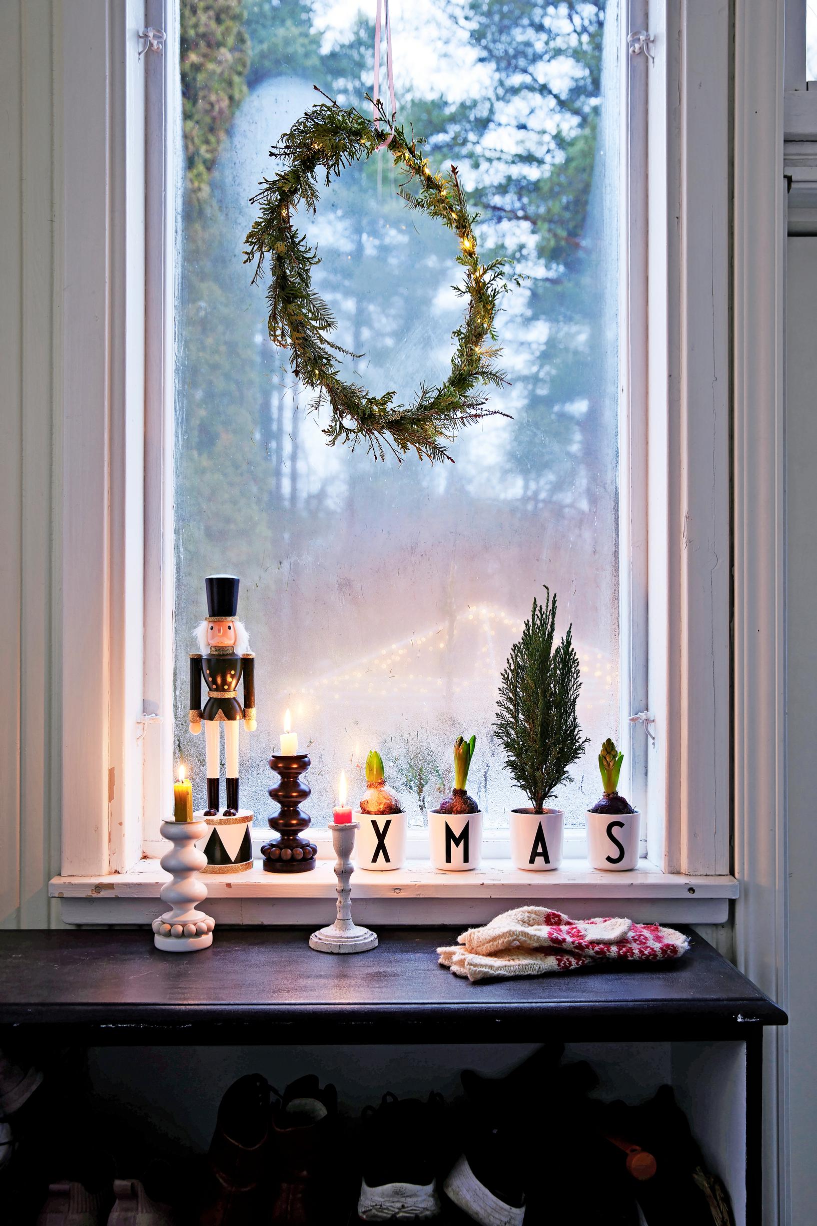 A Christmas-themed window display on the porch