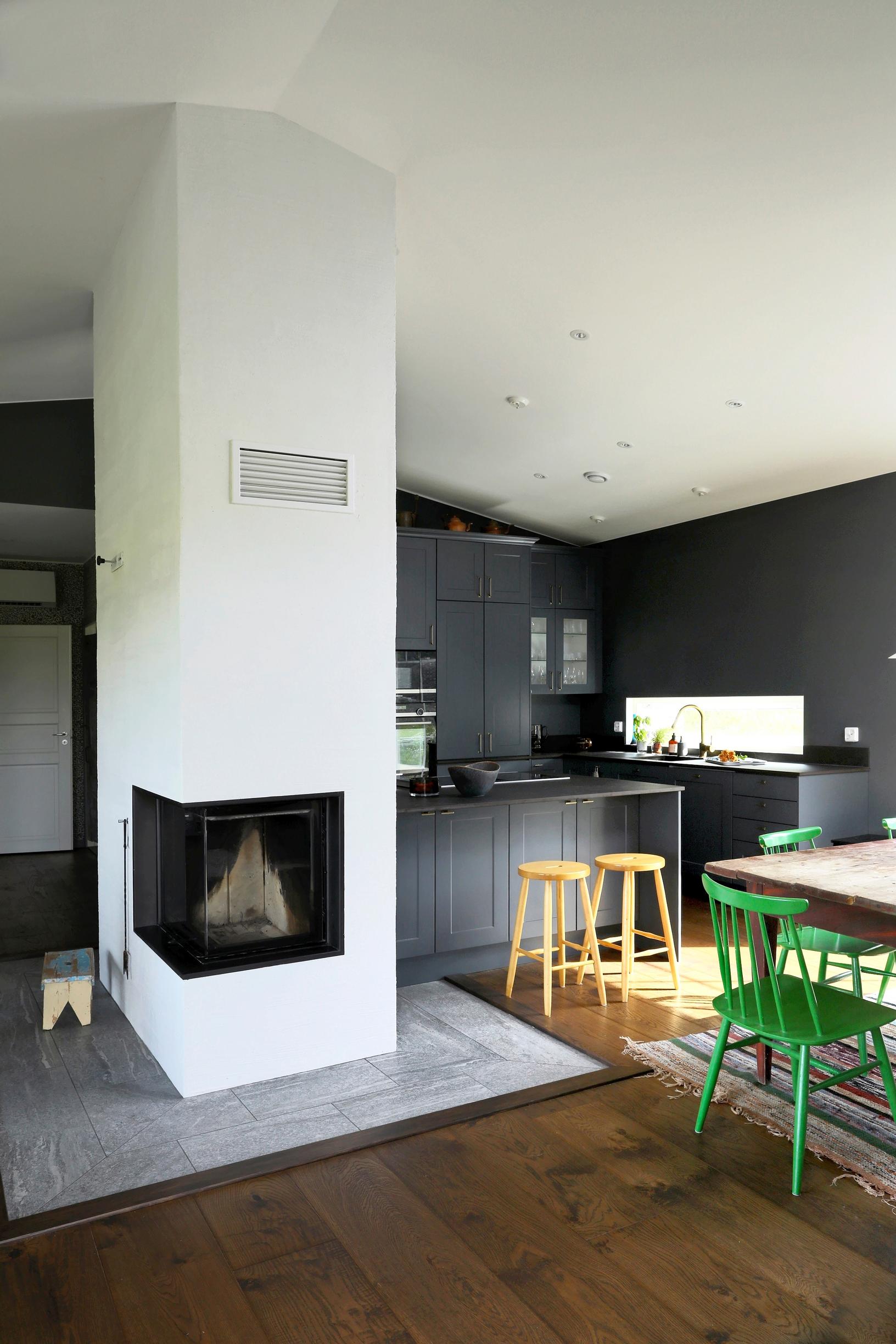 A white brick fireplace between the kitchen and living room.