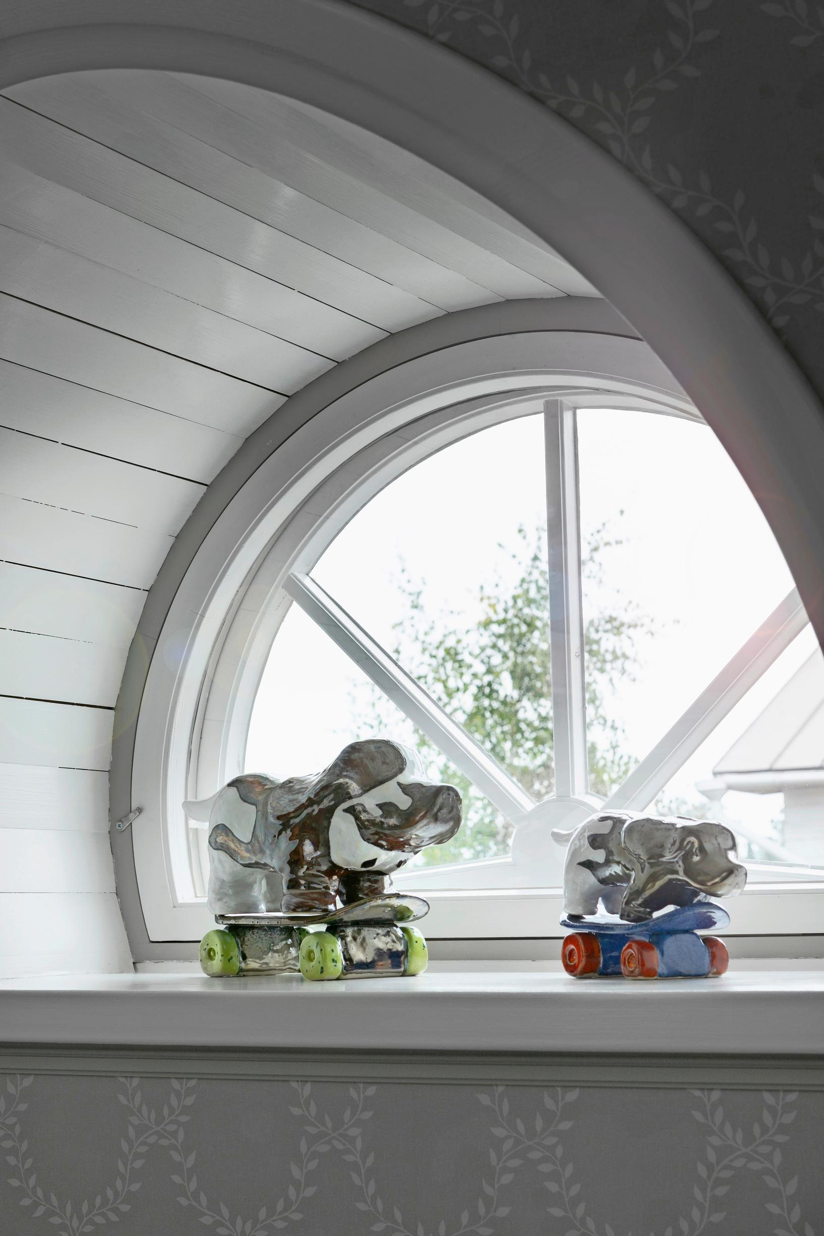 ceramic skateboarding dogs on a windowsill