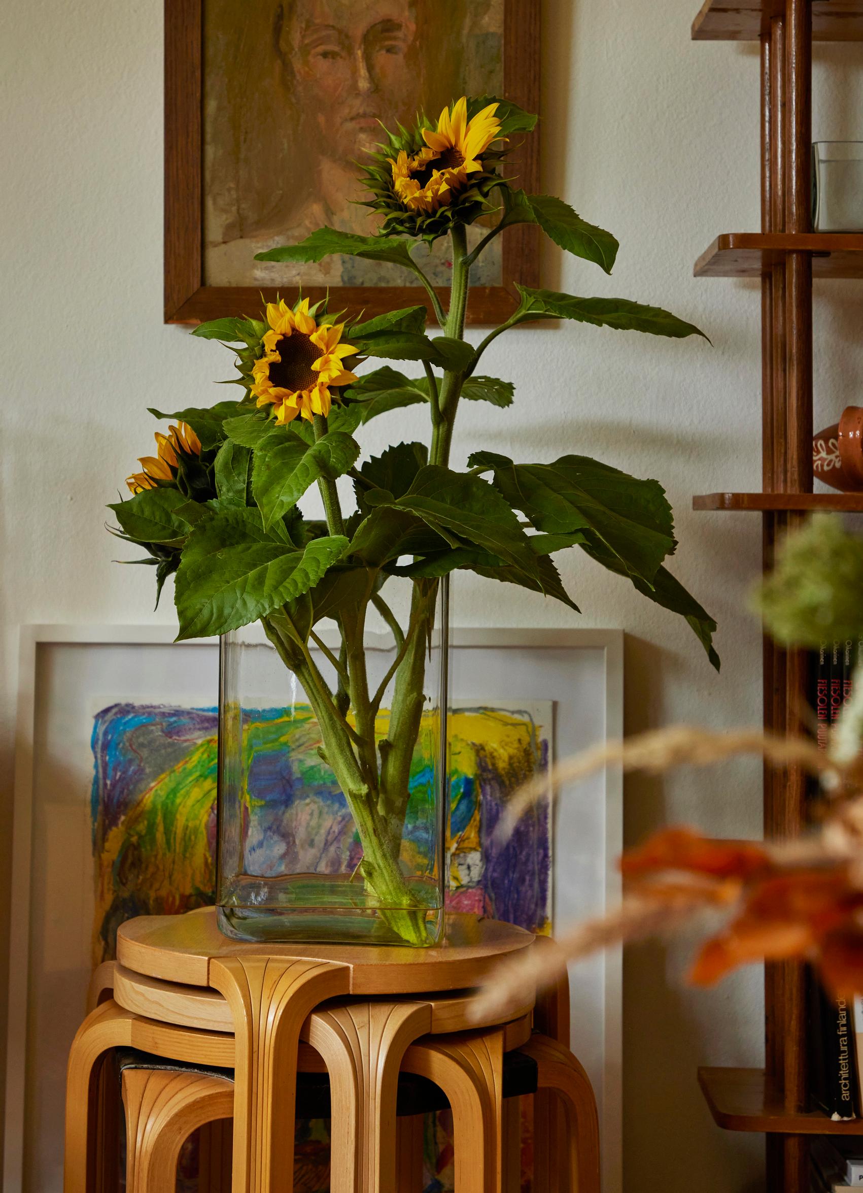Sunflowers in a vase on top of stools