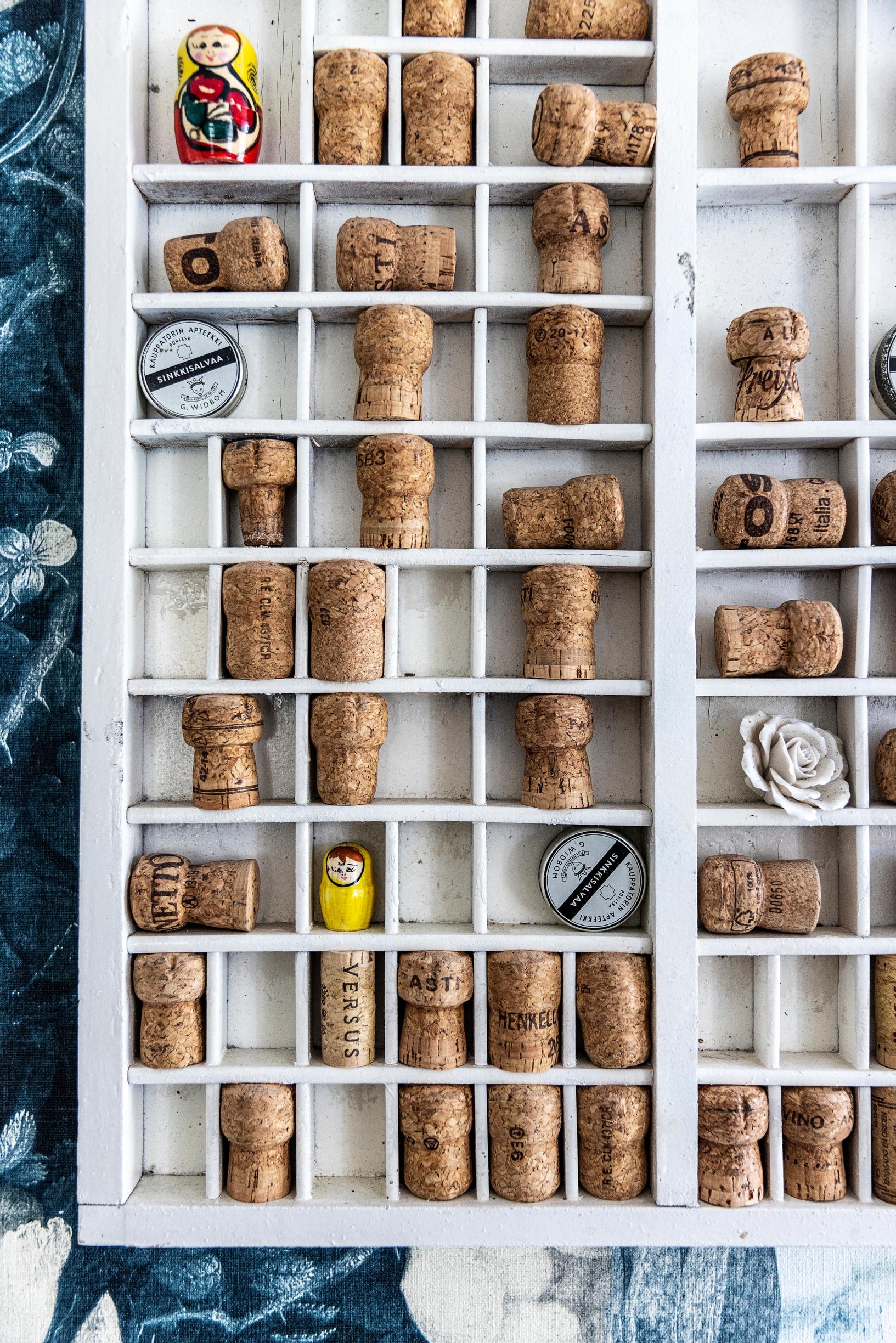 A wall shelf filled with wine corks and other small items