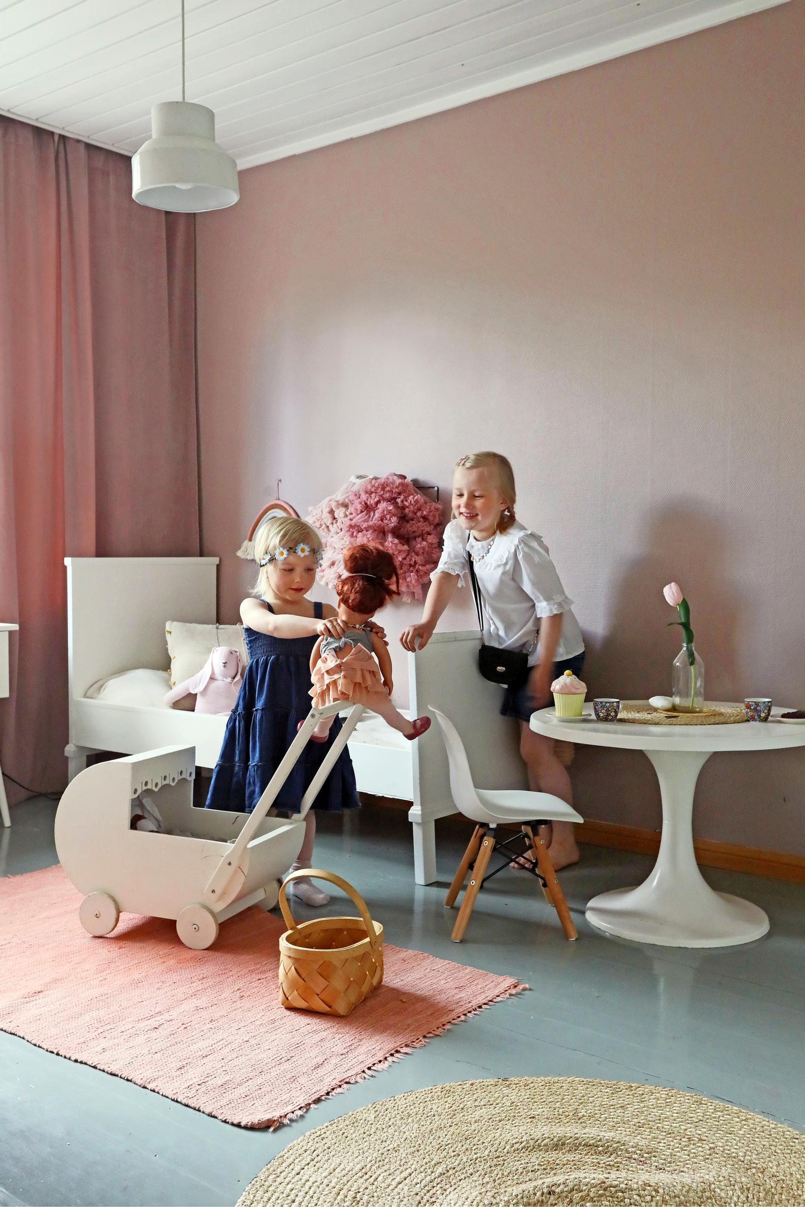 Photo of a children's room with a pink wall.