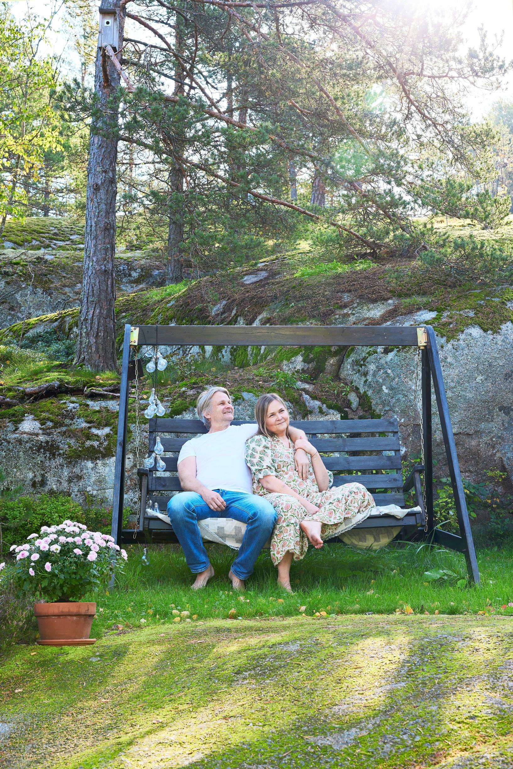Anu Karttunen and Marko Minkkinen on a garden swing