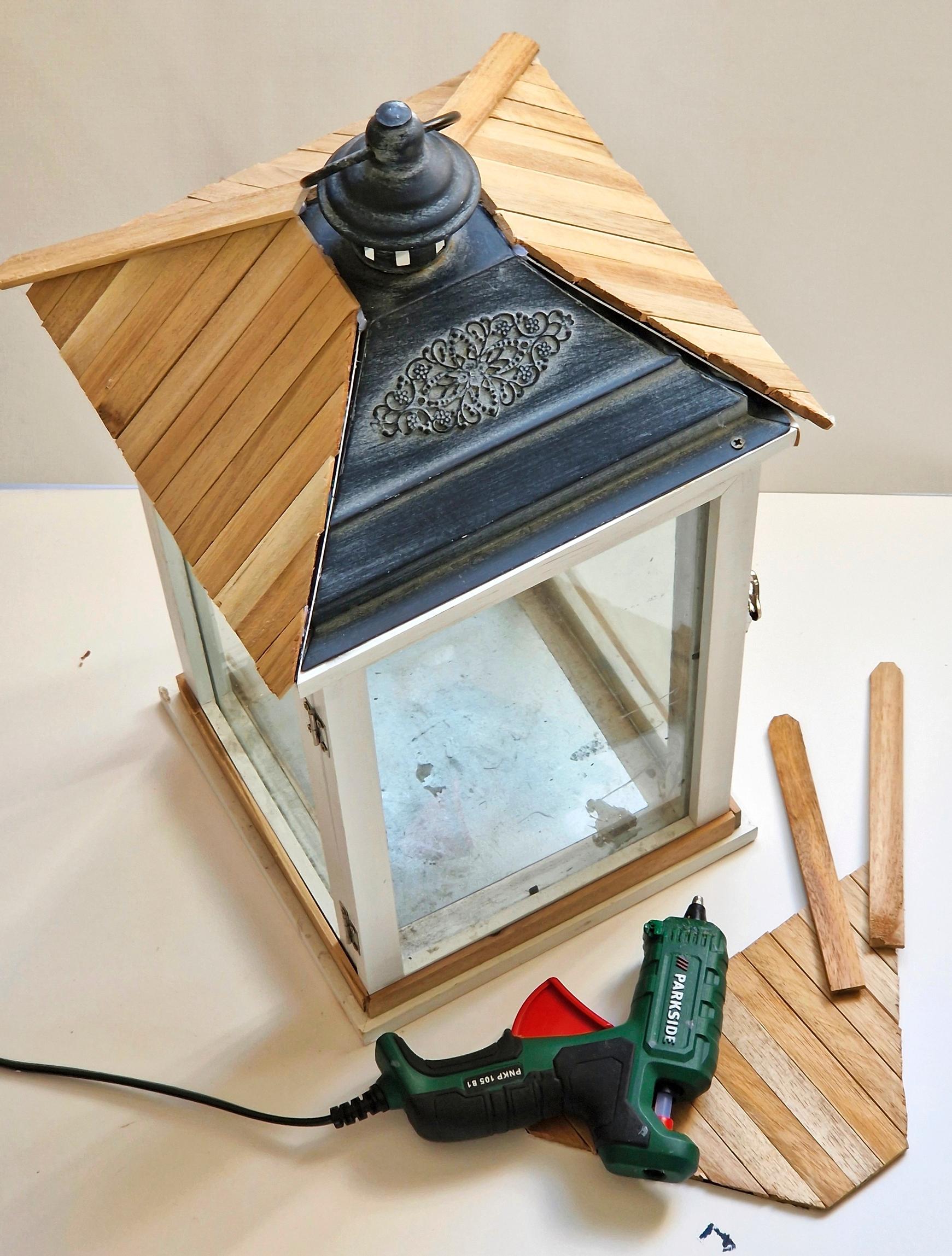 Attach the roof pieces to the lantern with hot glue.