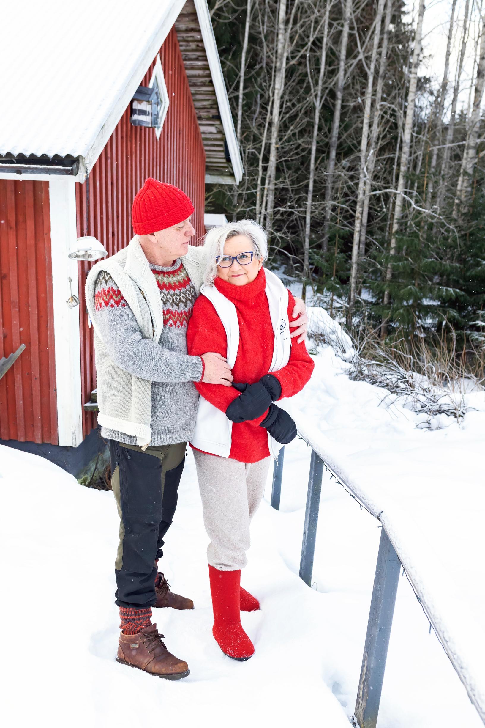 a man hugs a woman outdoors in winter