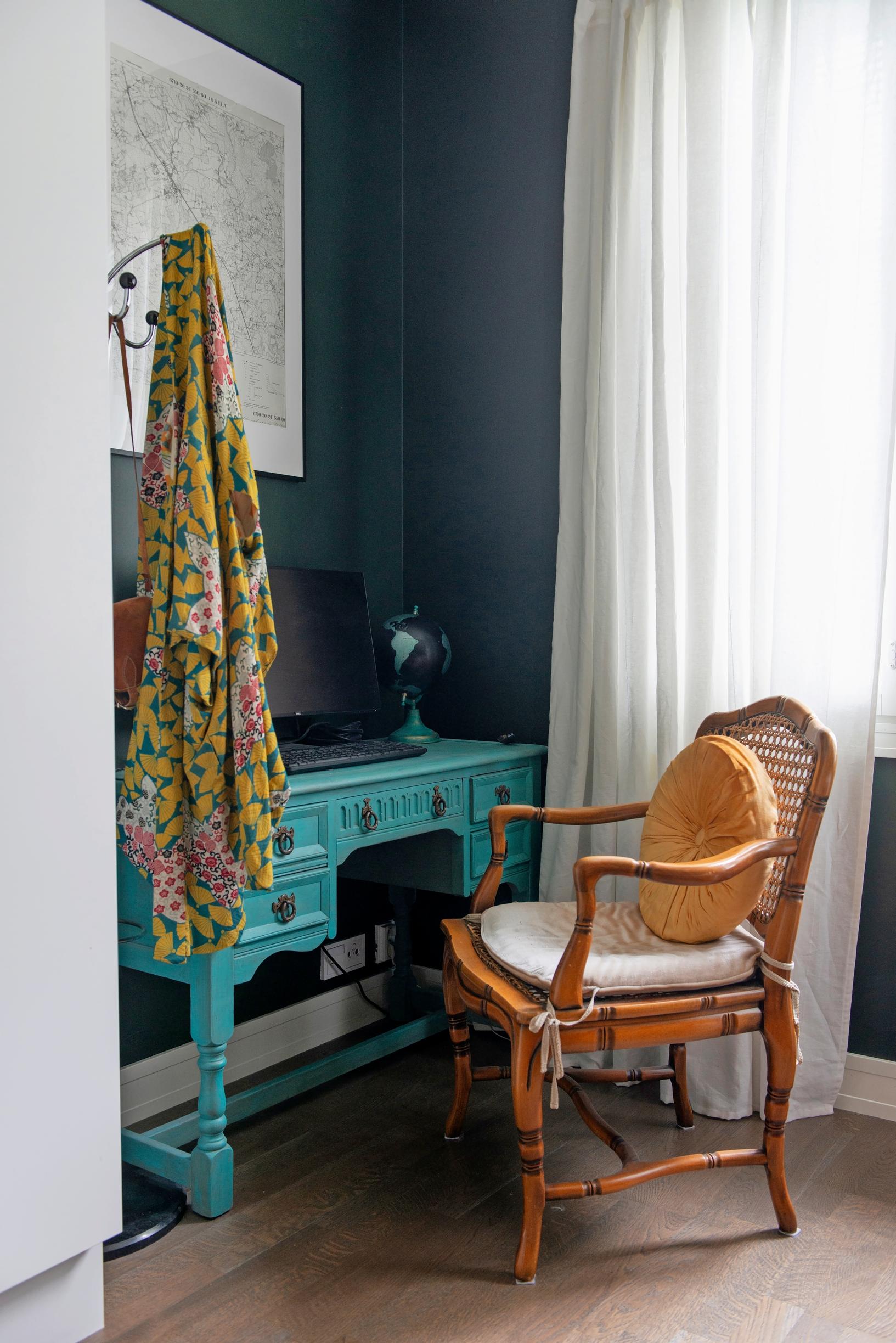 a turquoise desk in the workspace