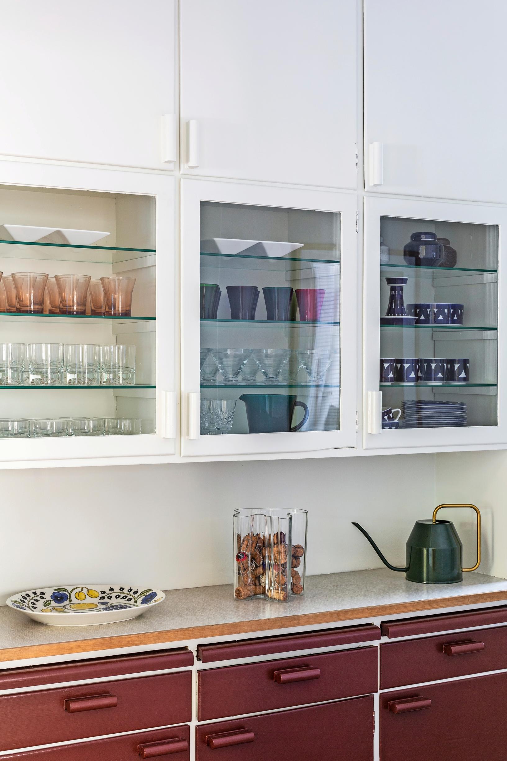 Original lower cabinets in the serving corridor painted red