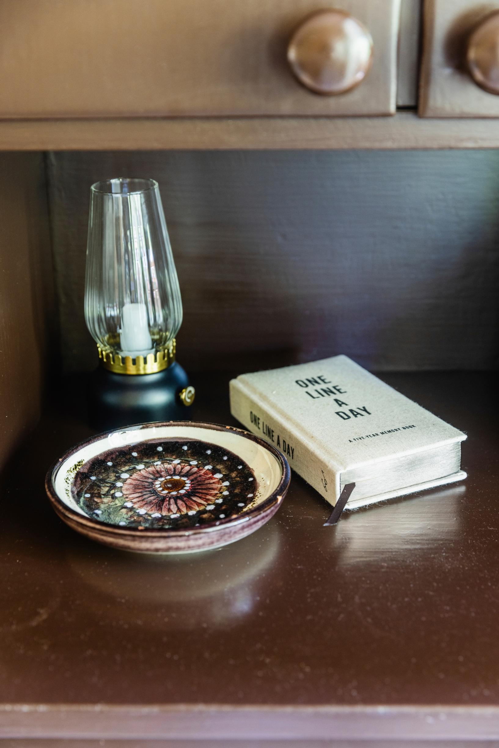 a kerosene lamp, a book and a plate
