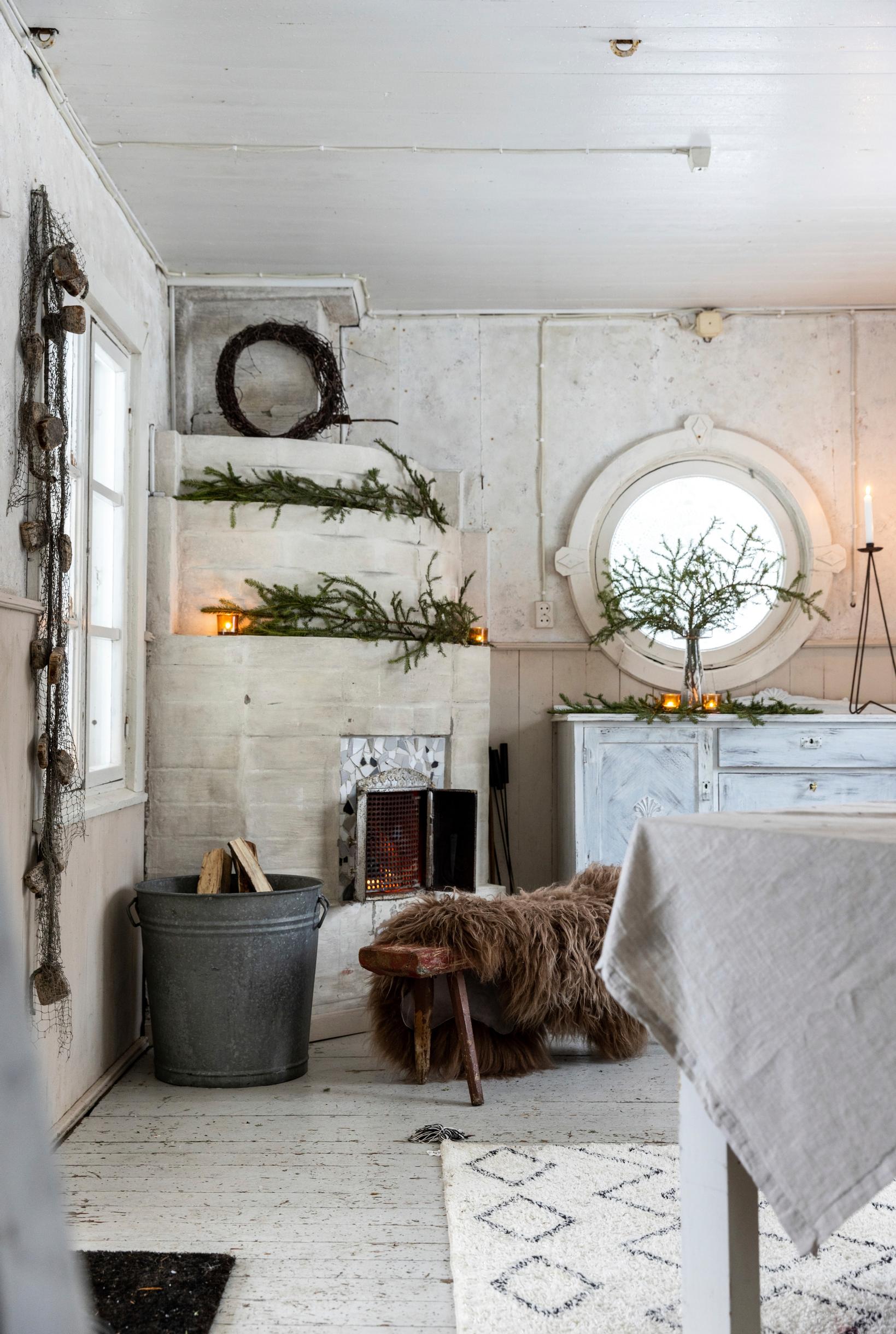 A fireplace in the corner of the lakeside cabin.