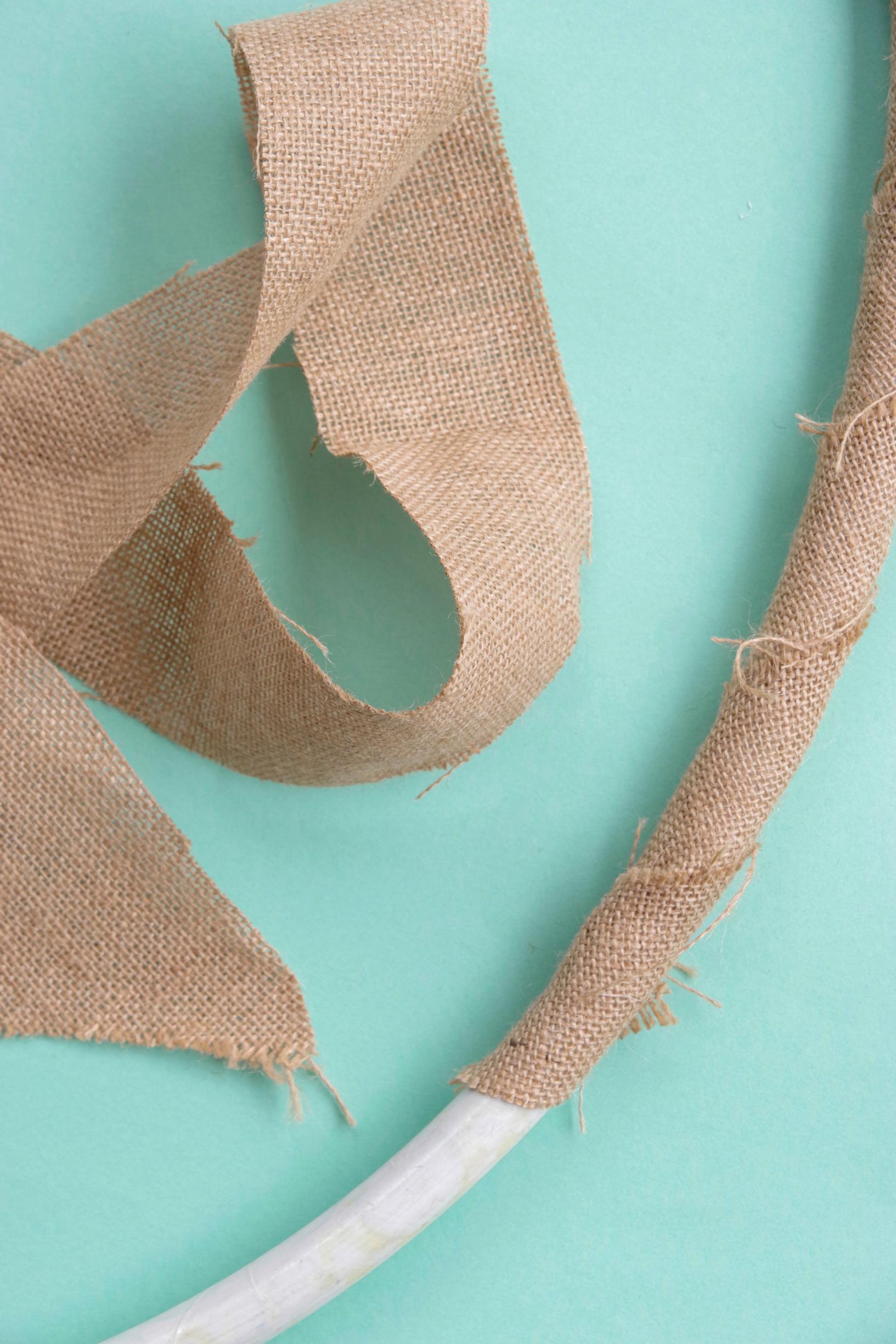 Wrap strips of burlap around the hoop.