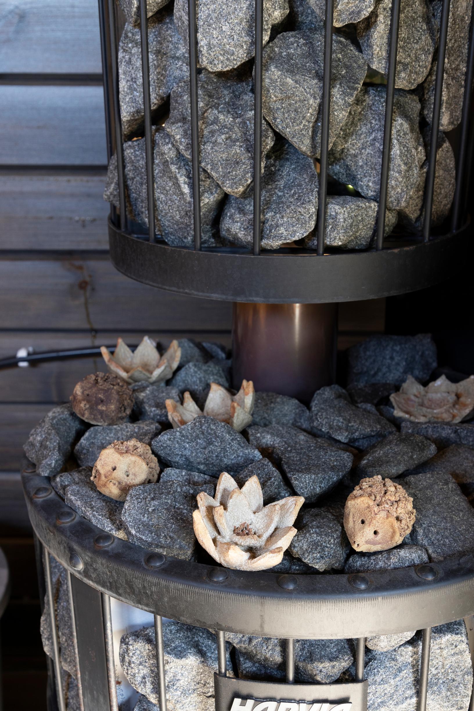 Ceramic sauna flowers made by Marita on the sauna’s stove