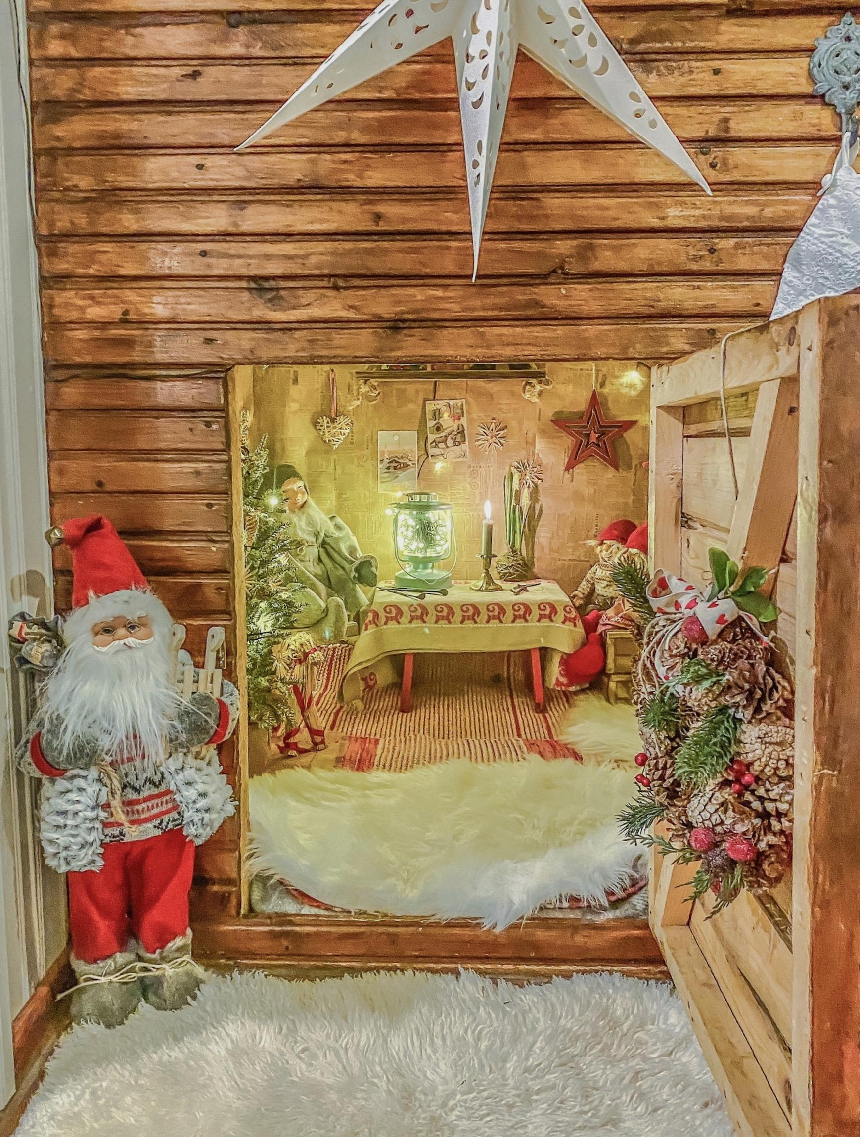 An elf stands at the door, welcoming visitors.