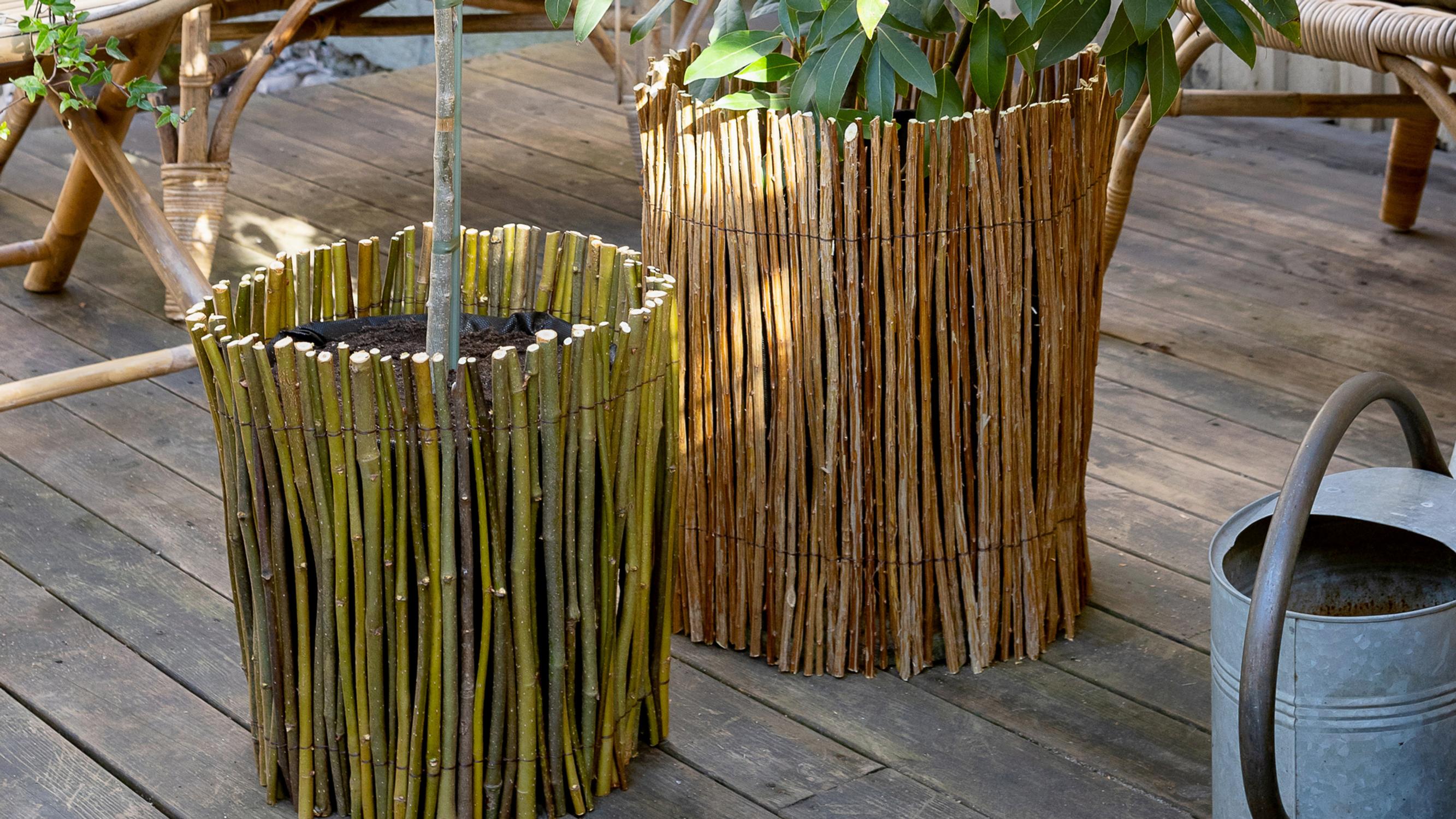 Just a bundle of twigs and some wire! Transform a shabby planting bucket—check out the easy tutorial