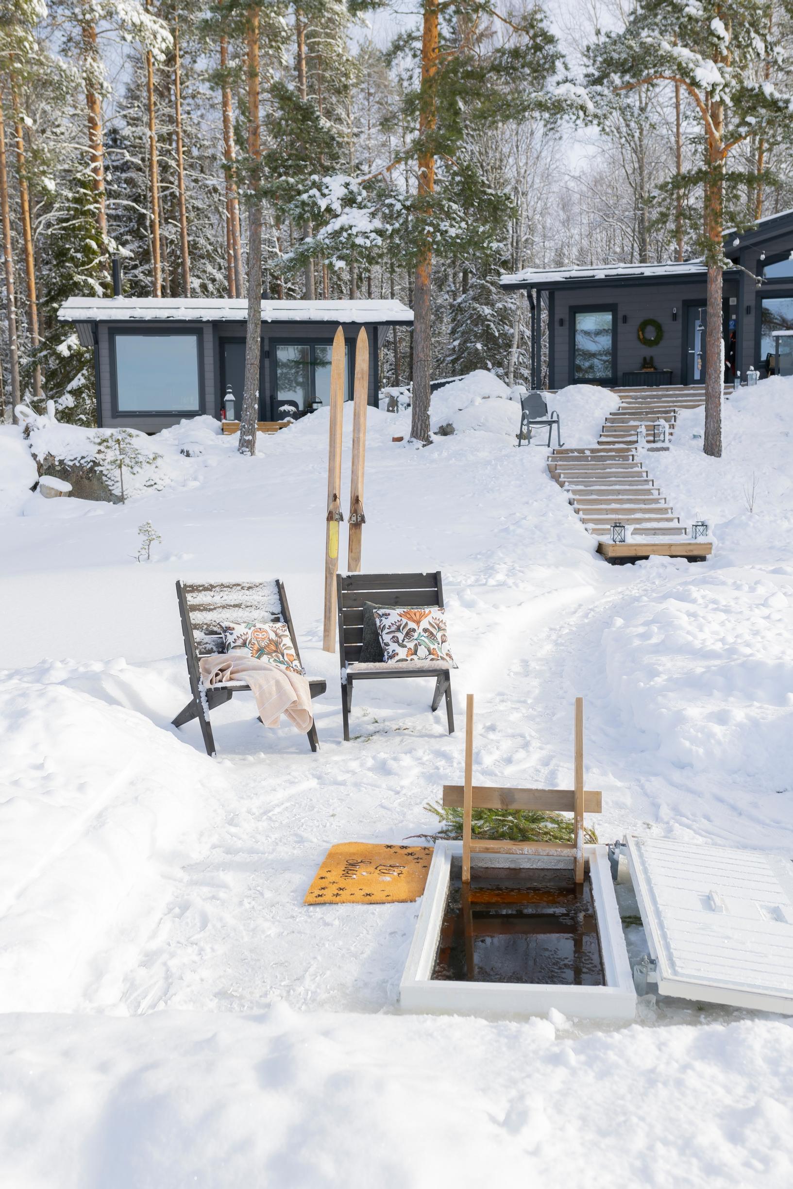 Two sun loungers, sauna building and cottage, ice hole