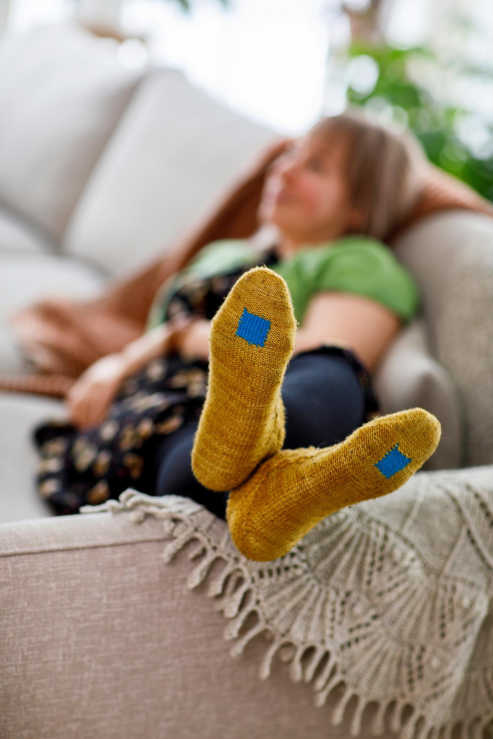 Wool socks with visible mending.