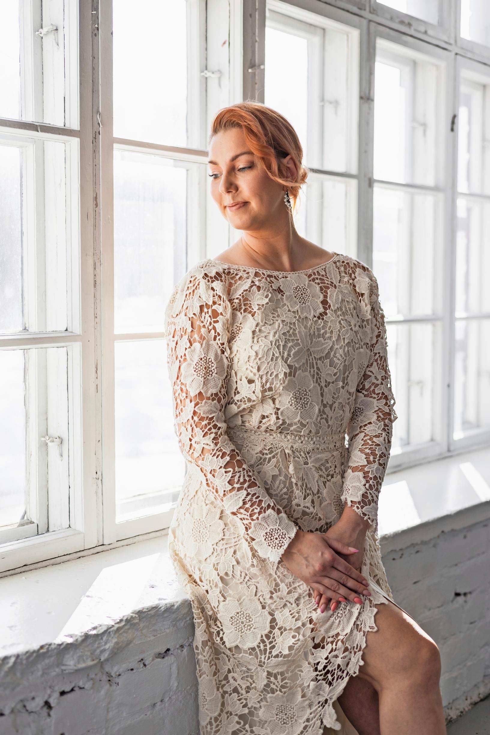 A lace wedding gown worn by a model.